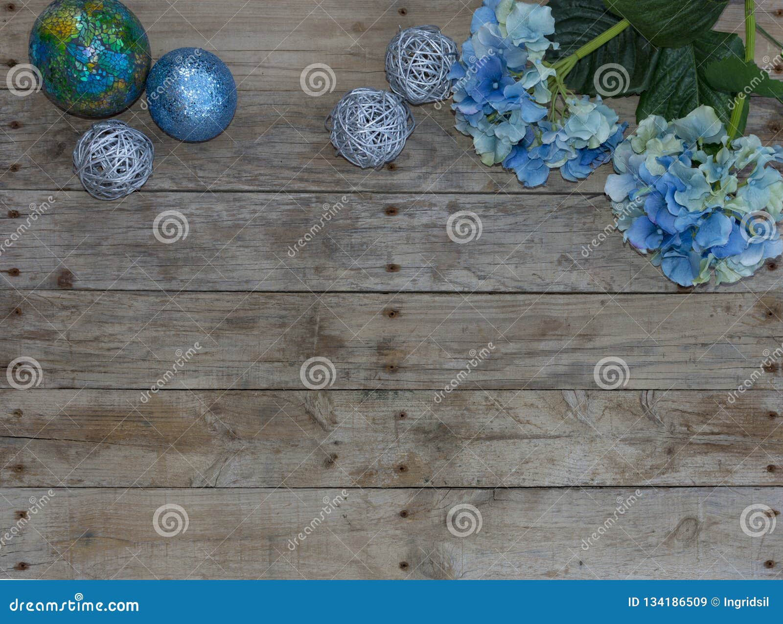 christmas postcard frame, wooden background for greeting card. blue glitter balls and turquoise flowers. xmas wallpaper