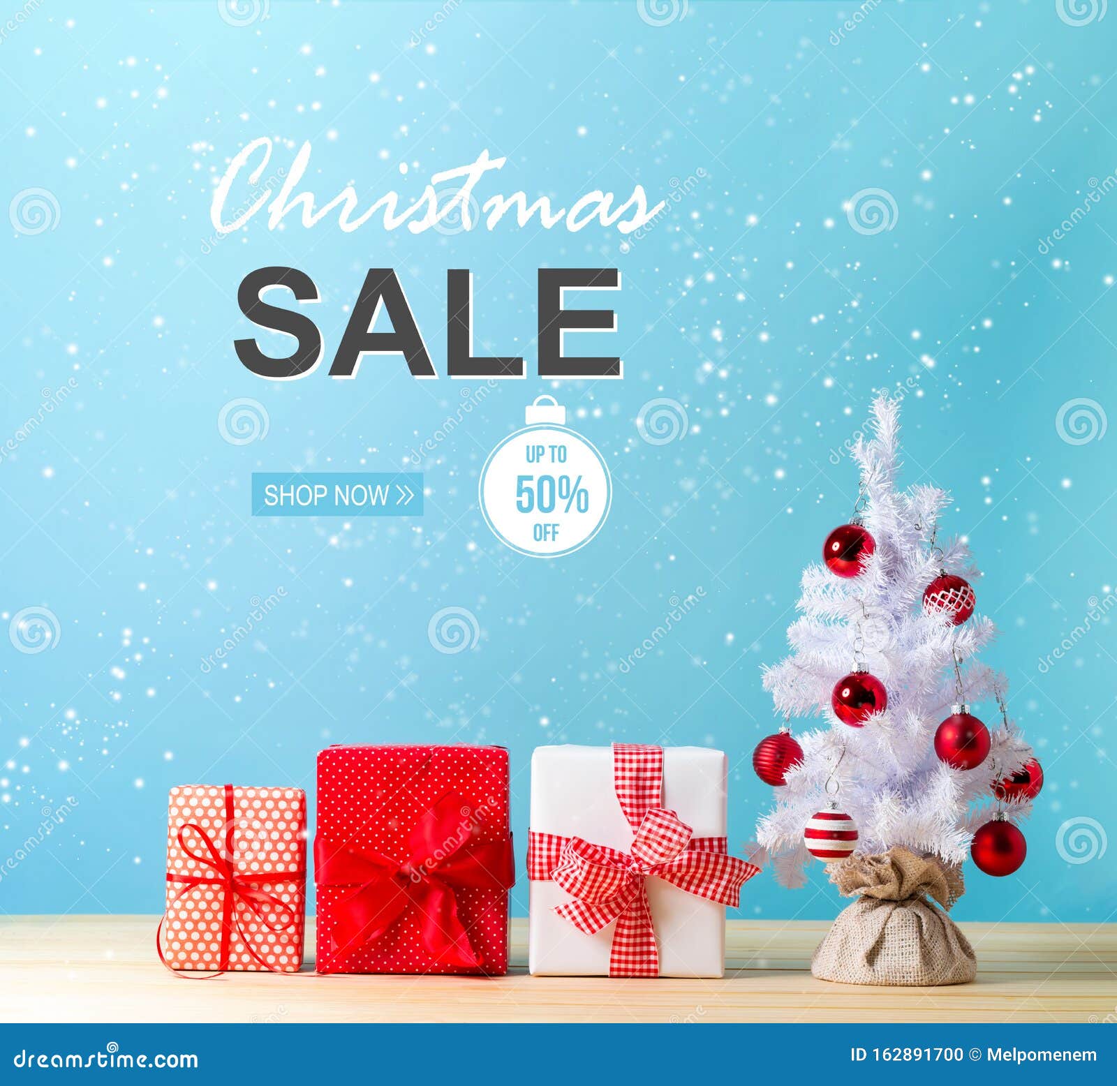 Christmas Sale Message with a Christmas Tree and Gift Boxes Stock Photo