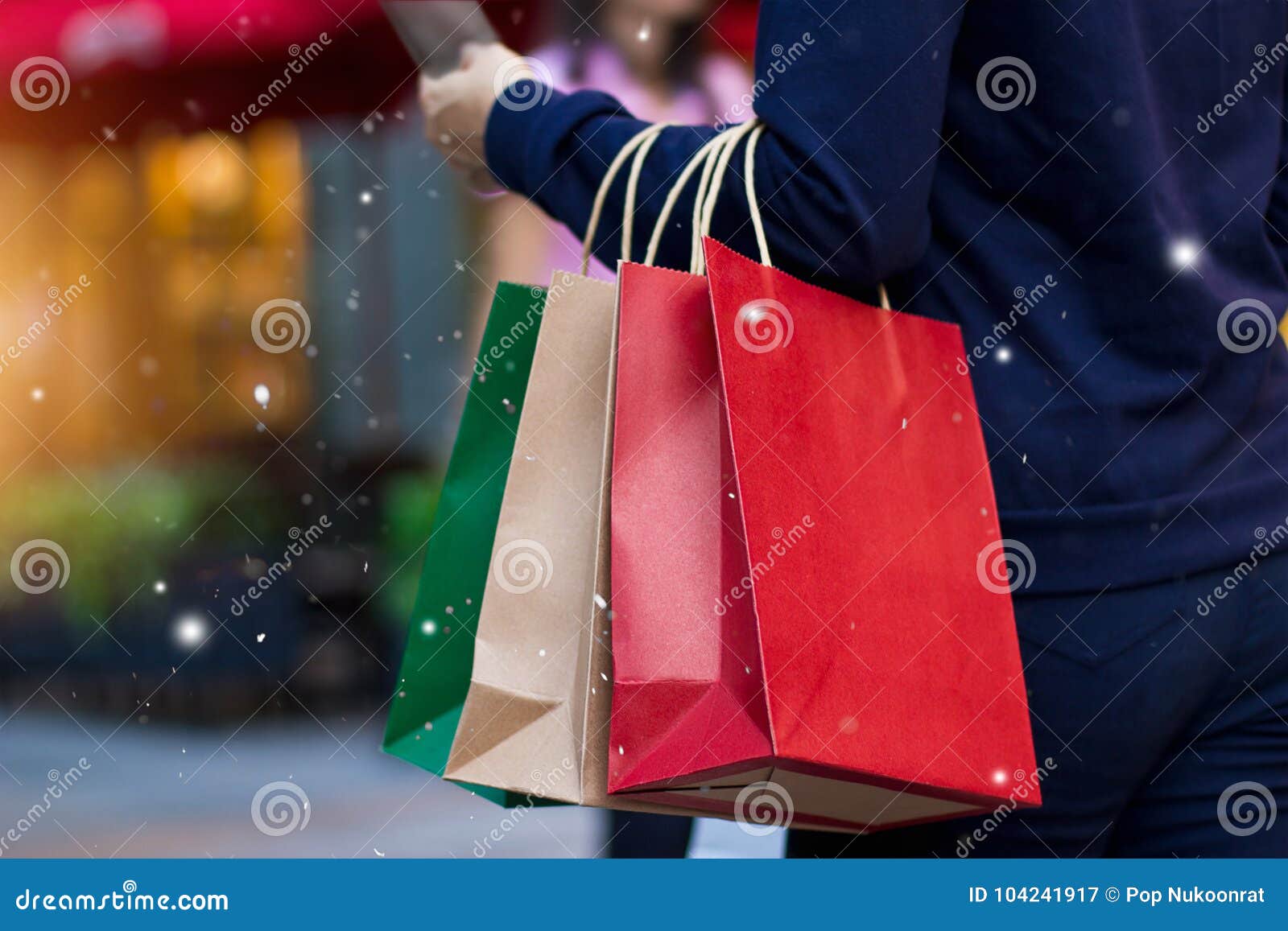 christmas shopping - shopping bags in hand with snowflake