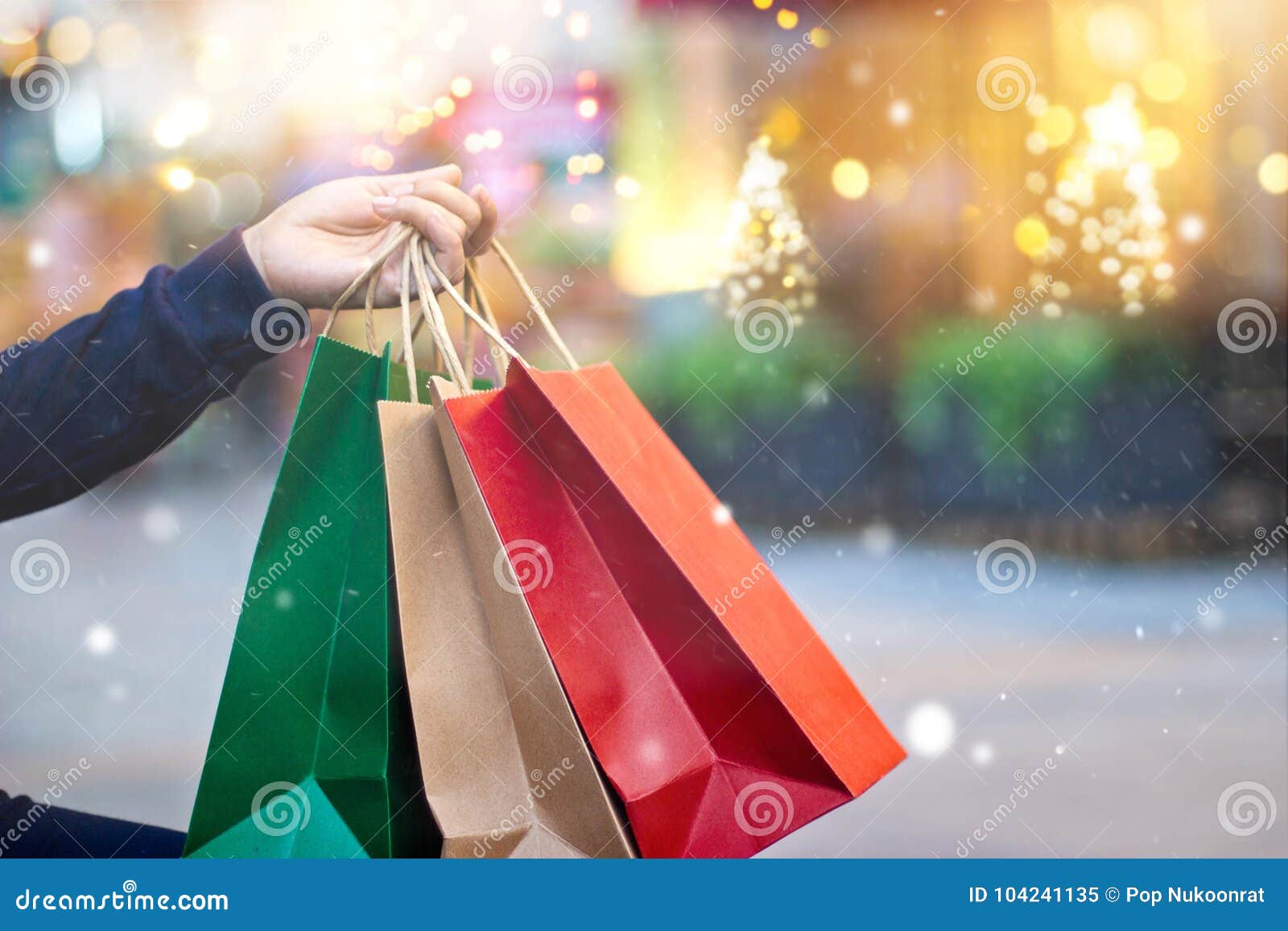 christmas shopping-shopping bags in hand with snowflake