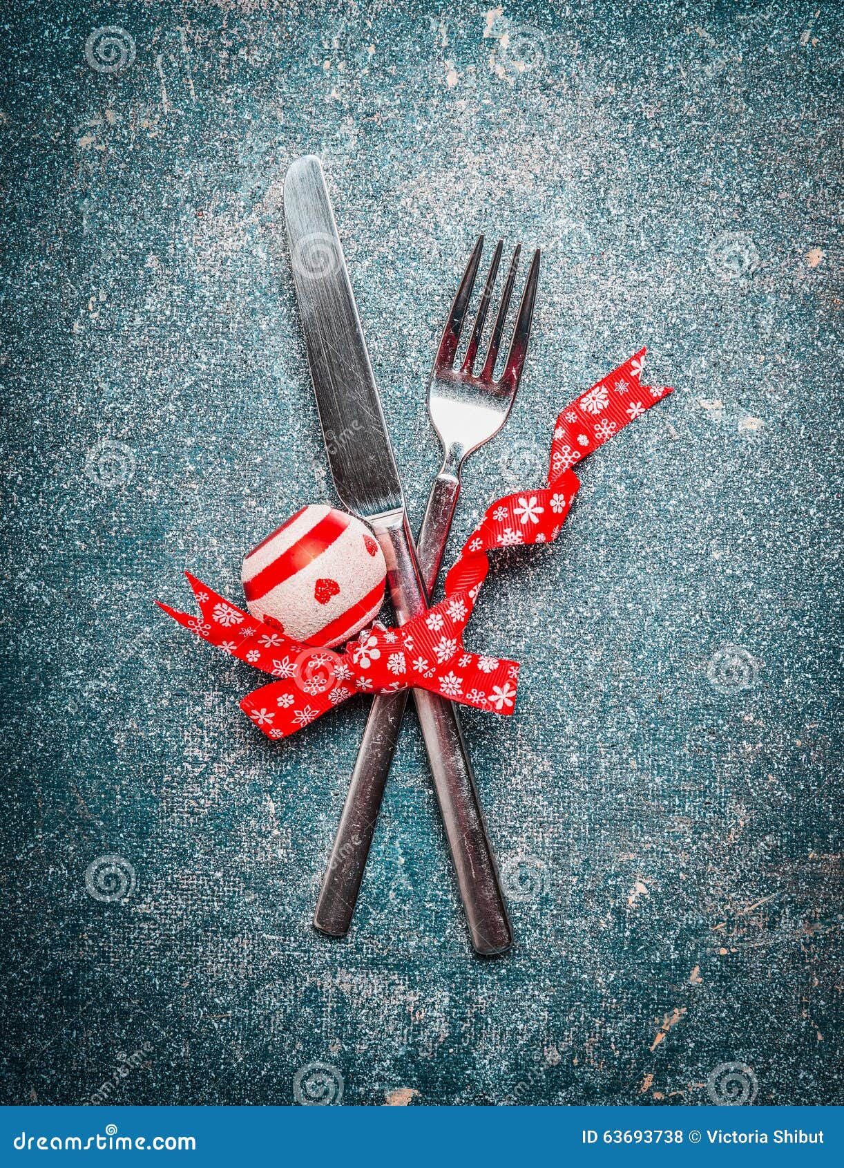 Christmas table place setting with fork, knife and red ribbon and ...