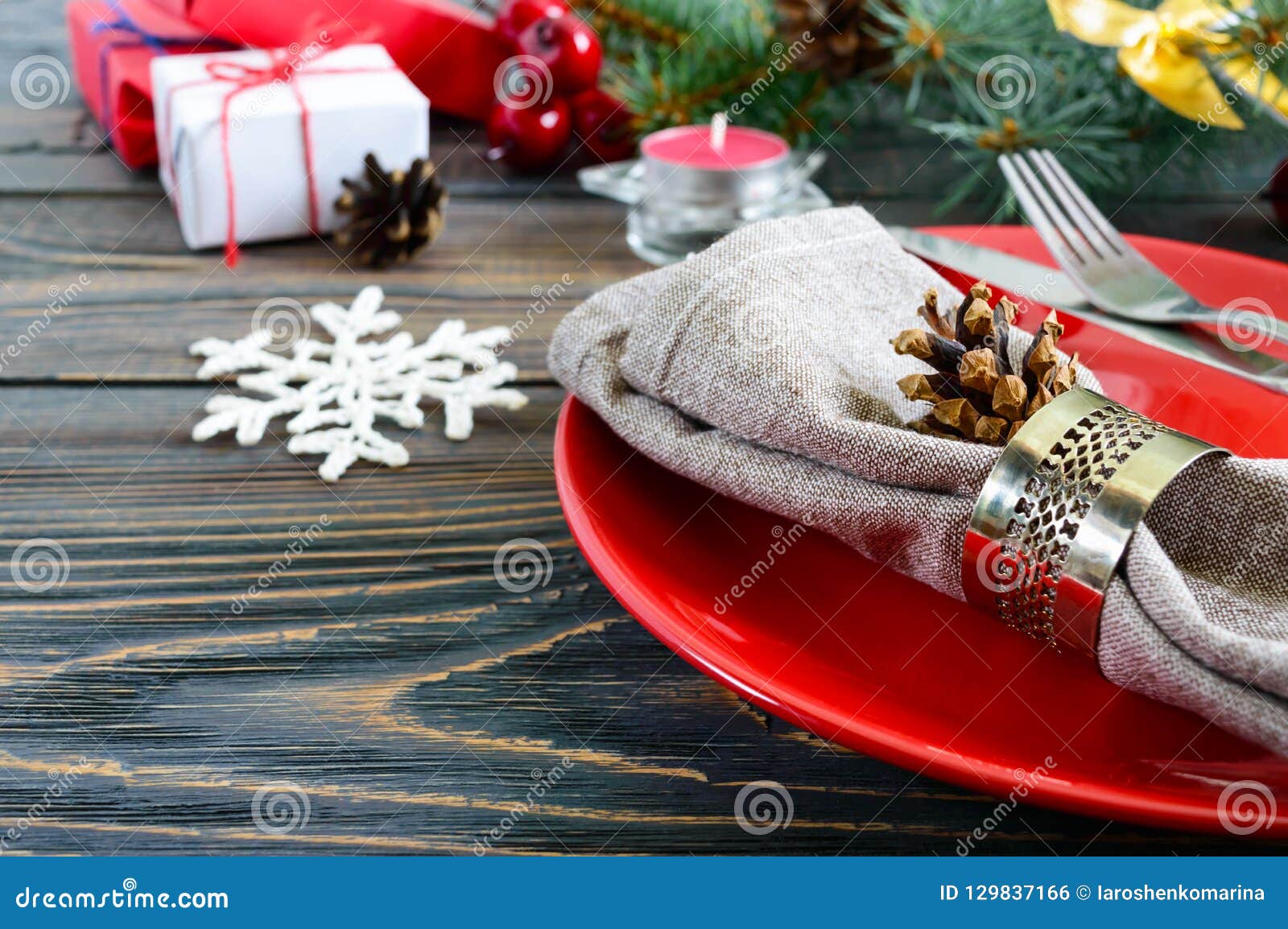 Christmas Table Setting. Red Plate, Fork, Knife, Candle, Napkin, Gifts ...