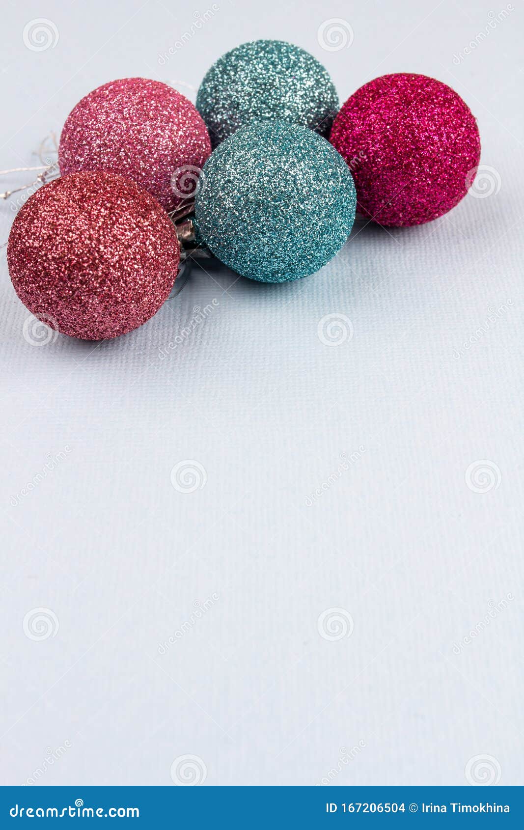 christmas tree colored balls lie on a light background