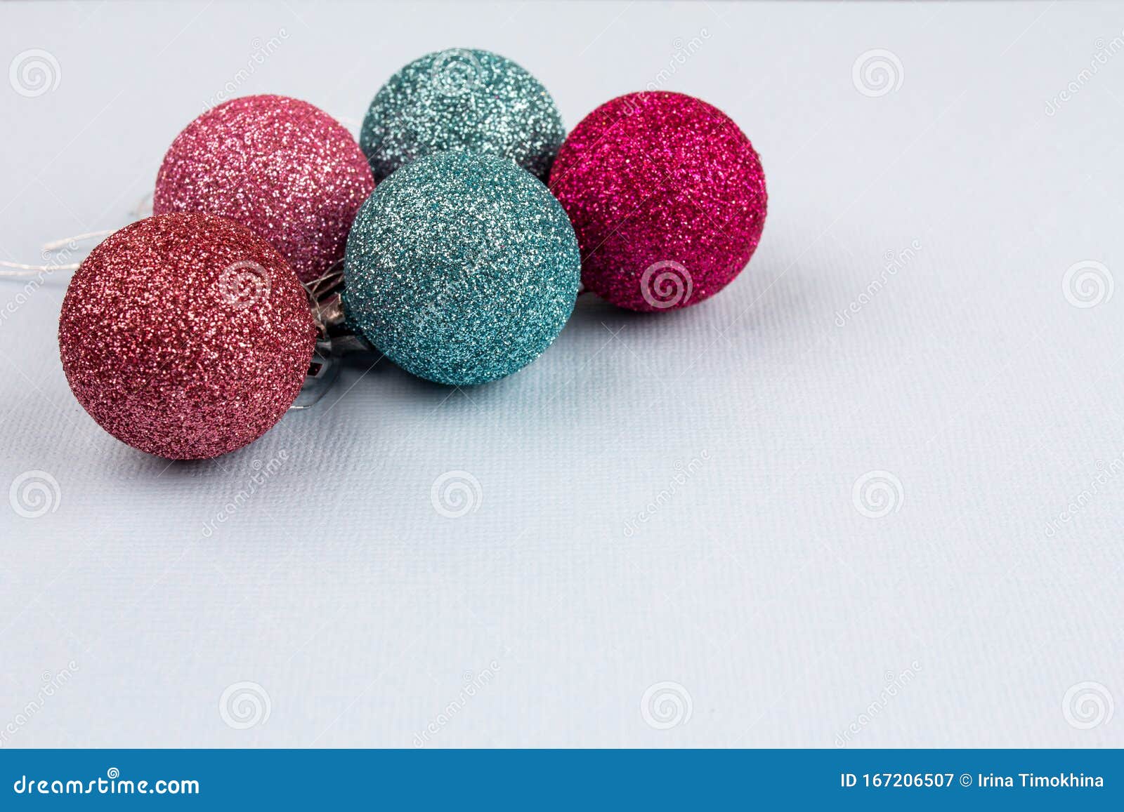 christmas tree colored balls lie on a light background