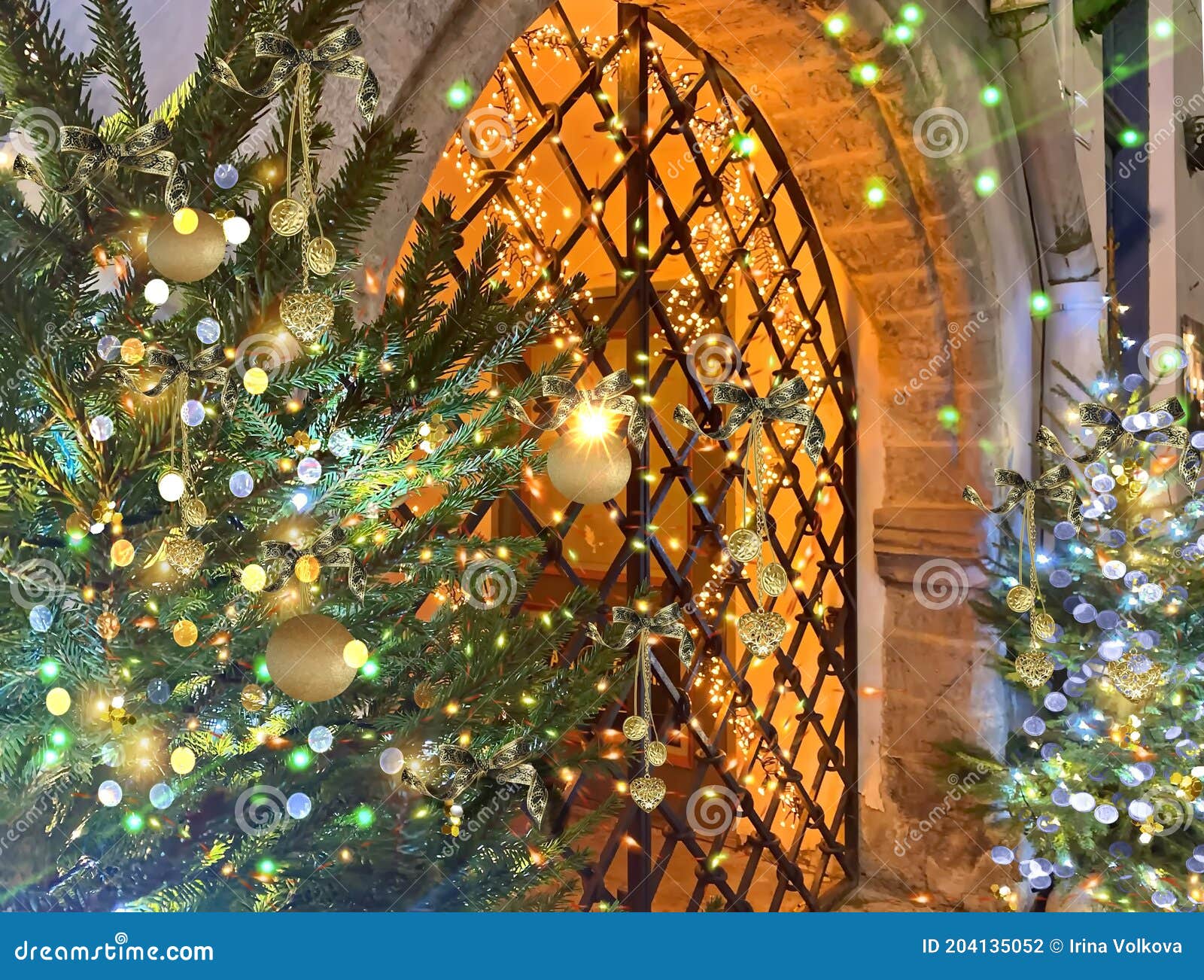 Christmas Tree Decoration Illuminated Gold Blue Light on Medieval Street Near Metal Decorative Gate Door in Tallinn Old Town Ho Stock Photo - Image of festive, green: 204135052
