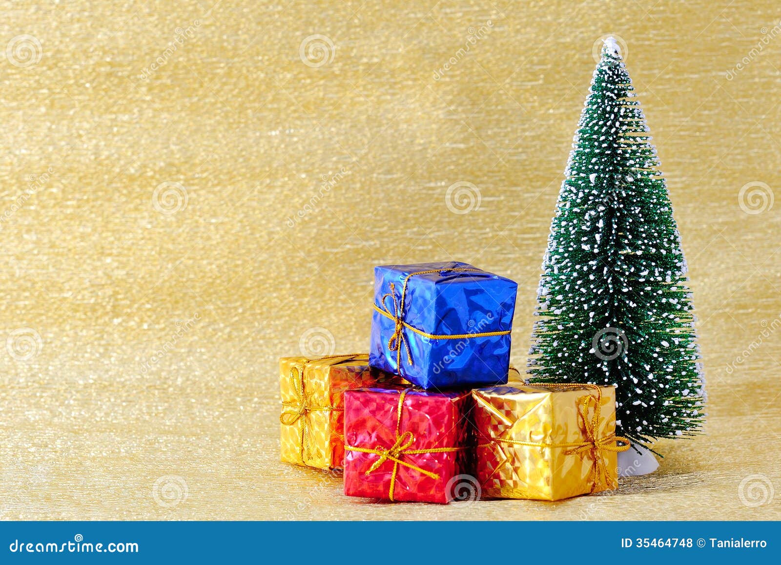 Christmas Tree and Gift Boxes on Golden Background Stock Photo Image