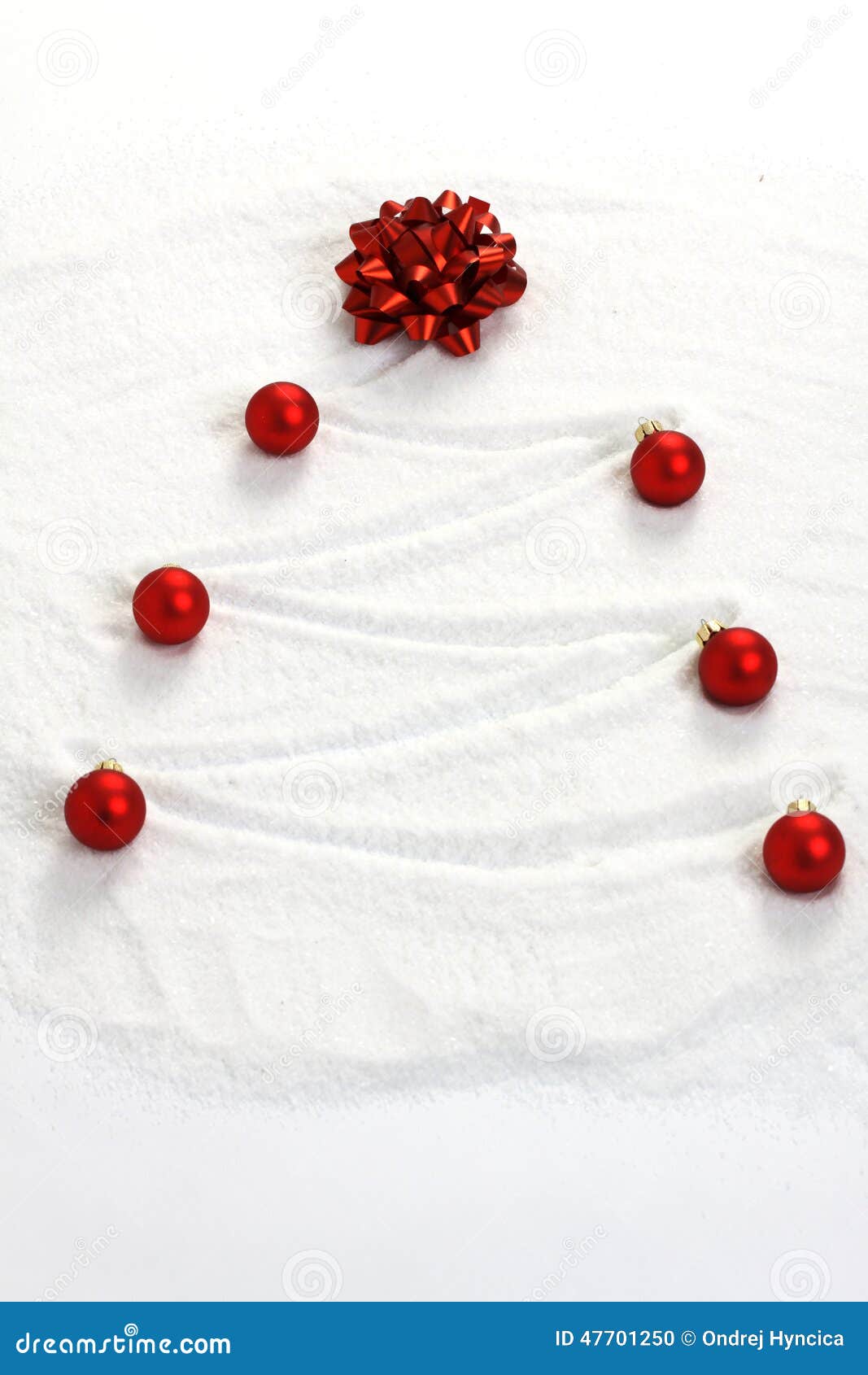 christmas tree painted in snow with red bow and red matt christmas balls