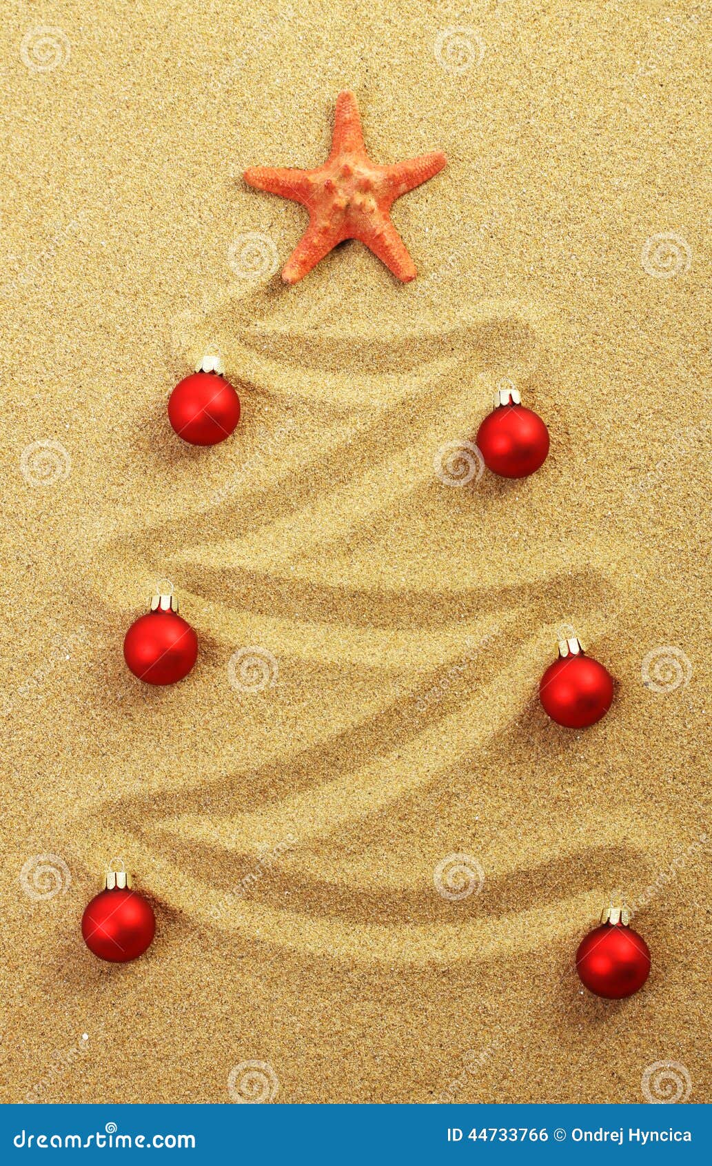 christmas tree on painting in sand with red starfish and red matt christmas balls