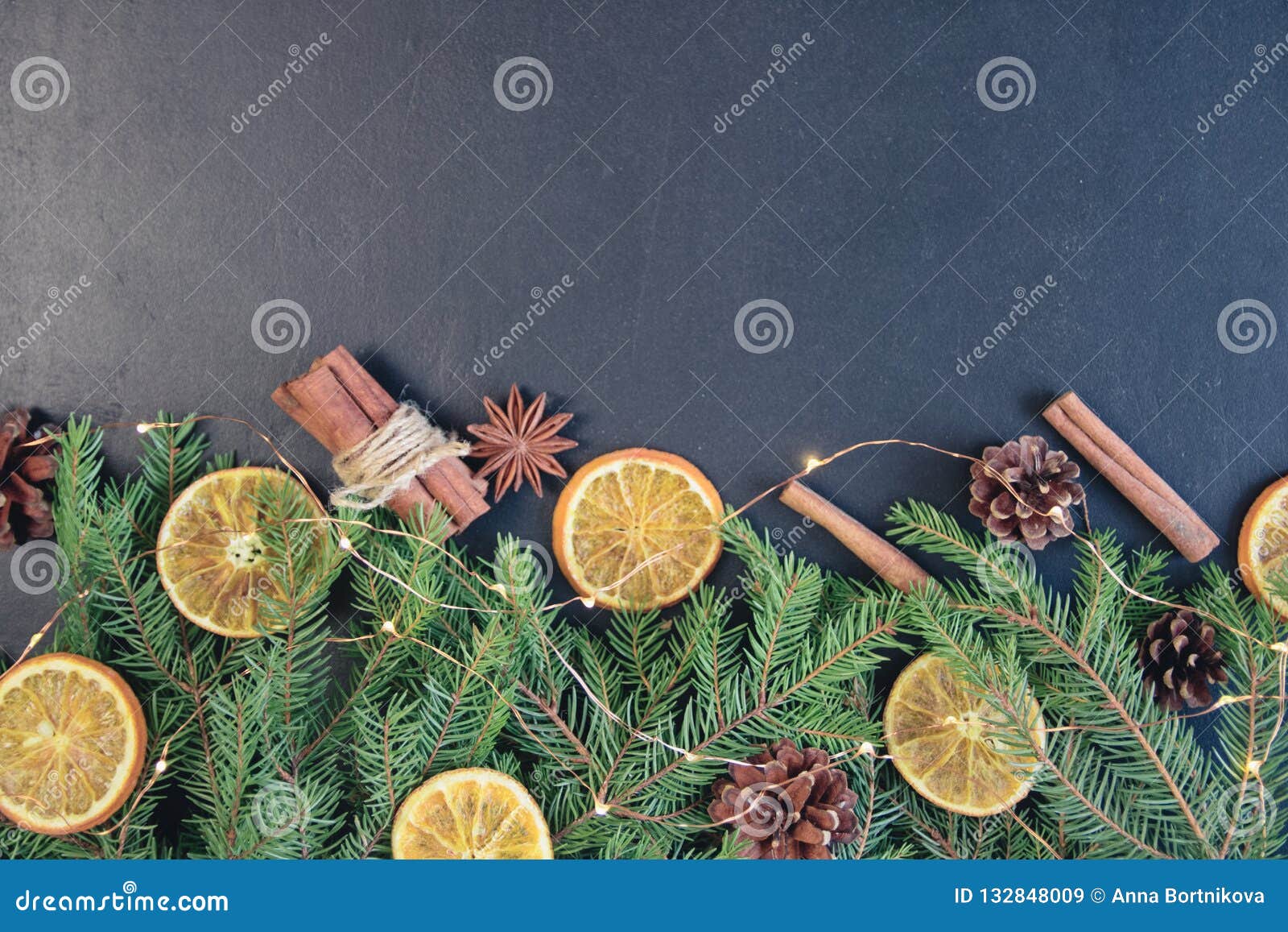 Christmas Tree Pine Branches with Dry Oranges. Cinnamon, Anise on a