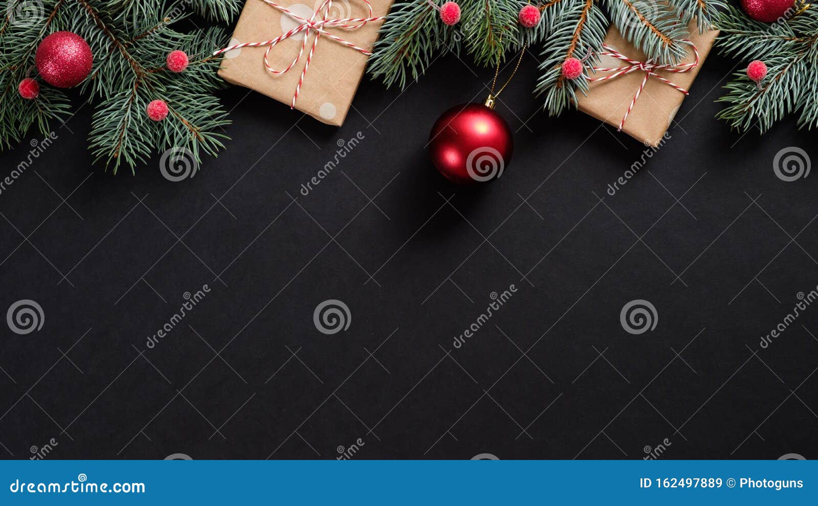 christmas tree with red decorations and gifts on black background. flat lay, top view, overhead. christmas banner mockup
