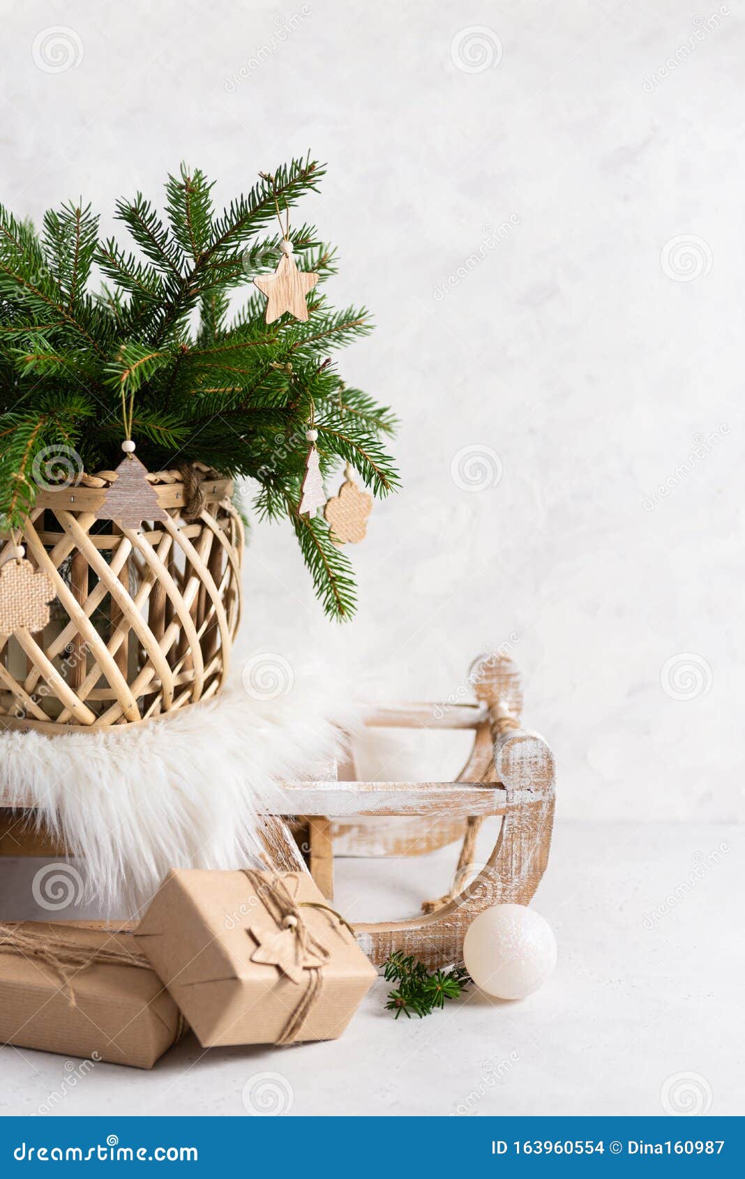 christmas tree on the sledge with presents in craft paper on white background. rustic, scandy style. new year, christmas greeting