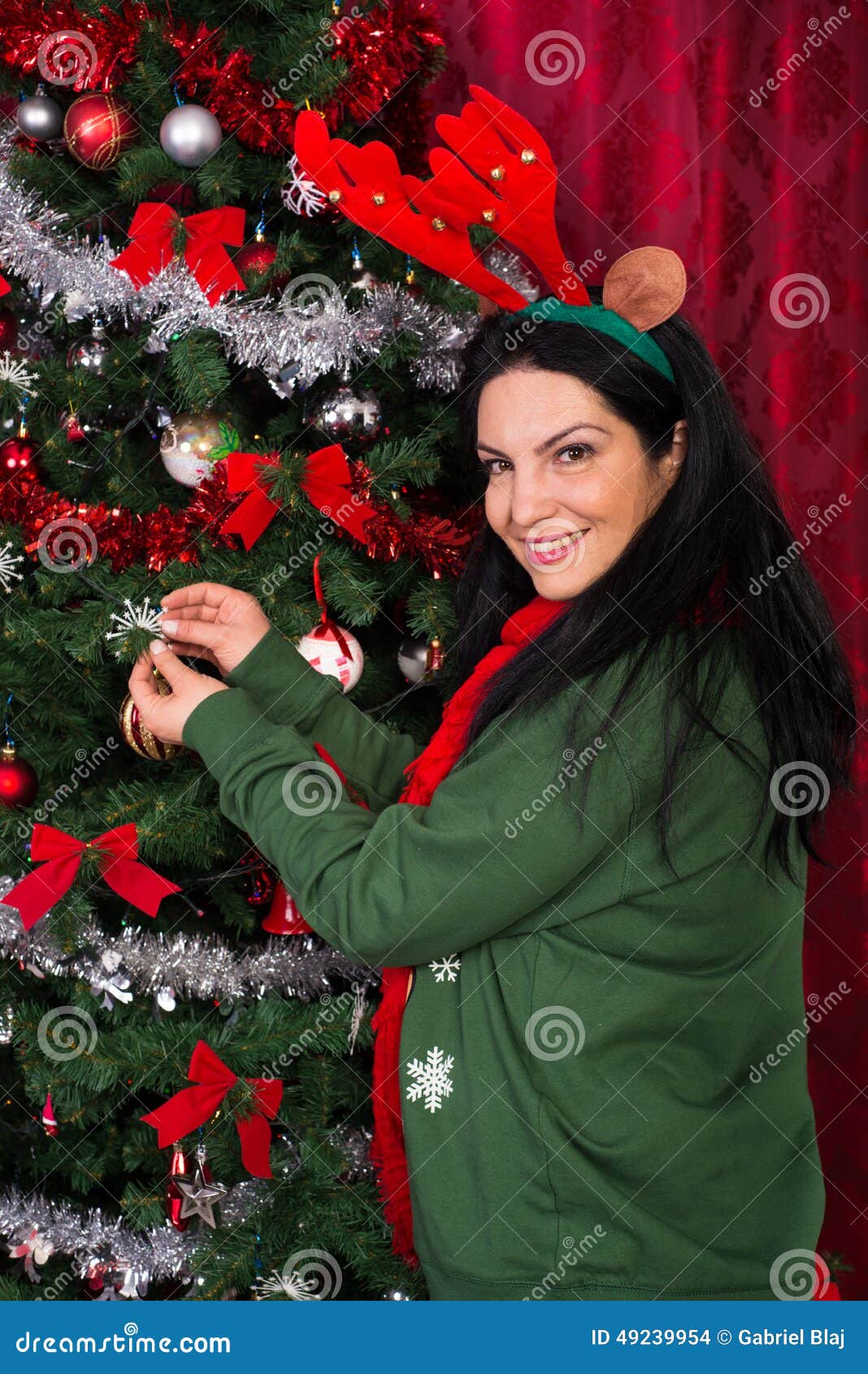 christmas woman decorates tree