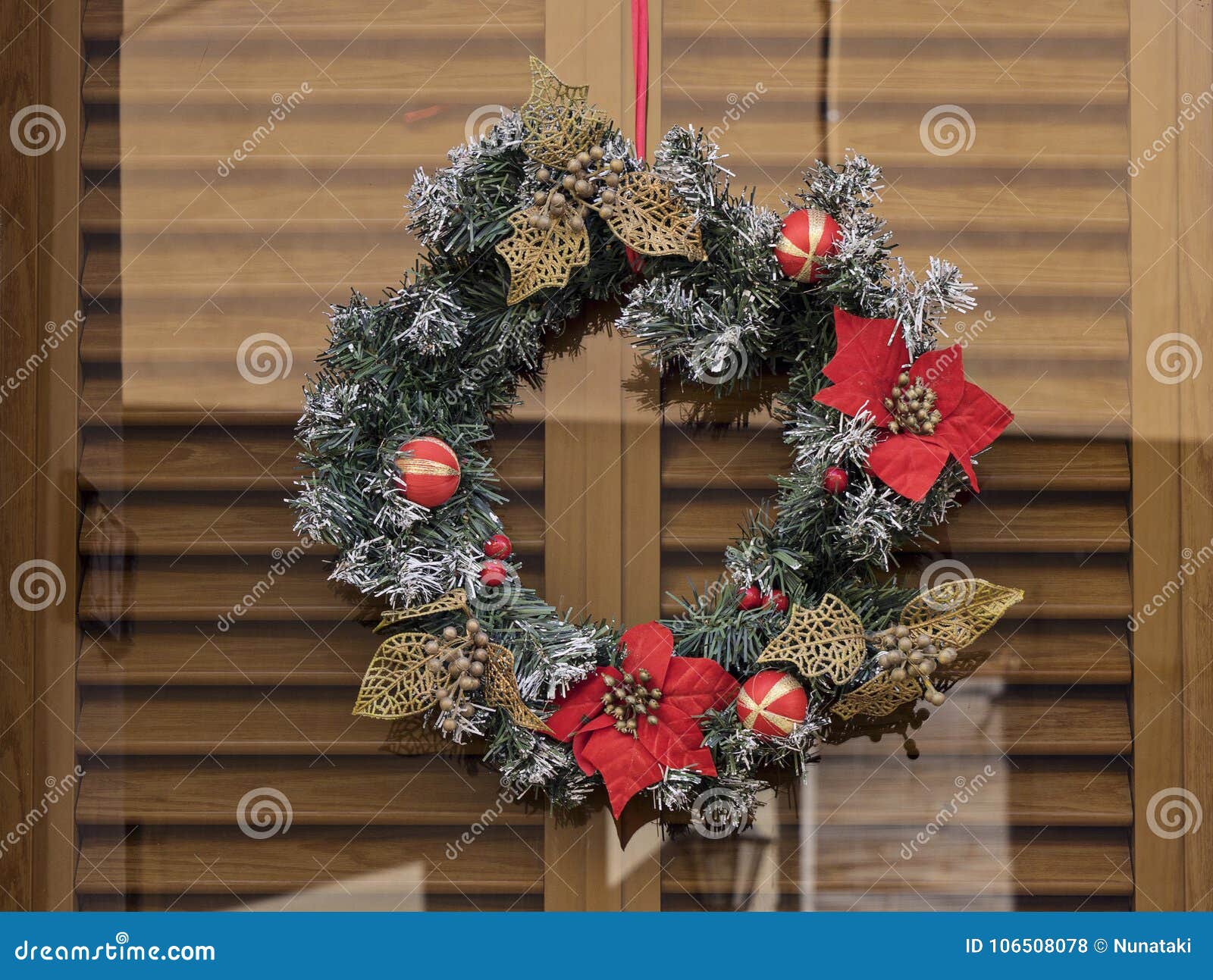 Christmas Wreath with Flowers Poinsettia on Glass Door Stock Photo ...