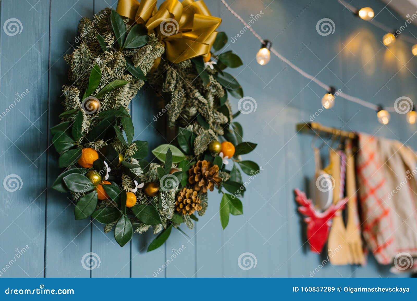 christmas wreath hanging on blue annoyance wall with lights on it, decor apartment or kitchen