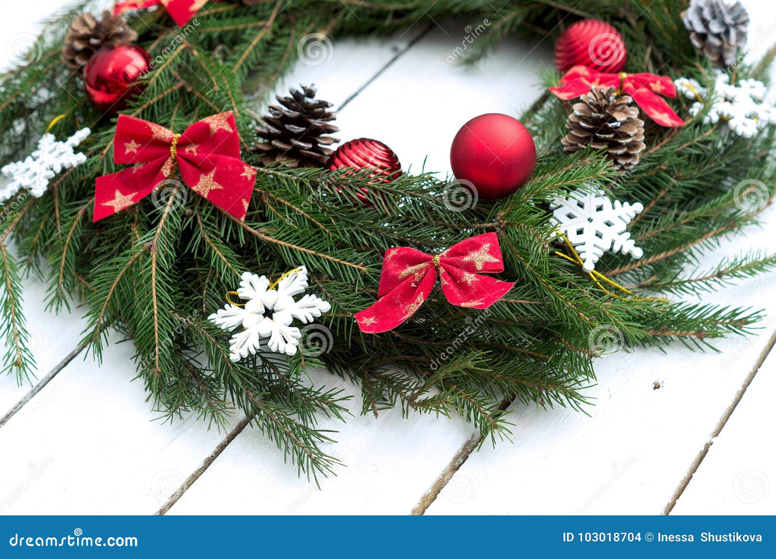 Christmas wreath of tree branches on wooden background