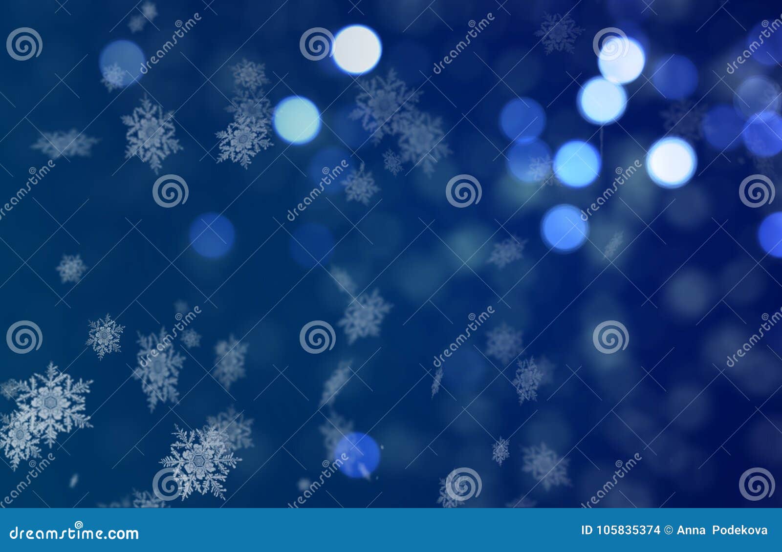 christmass mood snowflakes falling on a blue bokeh background