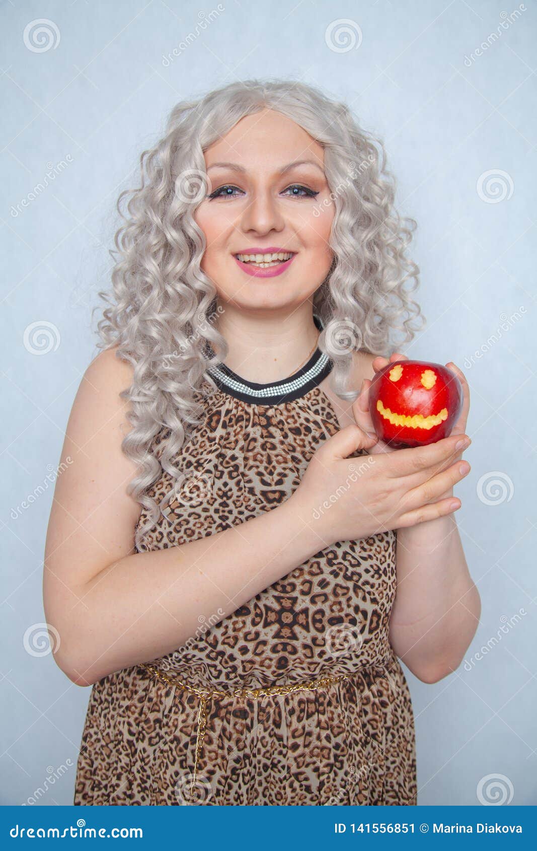 Chubby Blonde Girl Wearing Summer Dress And Posing With Big Red Apple On White Background Alone