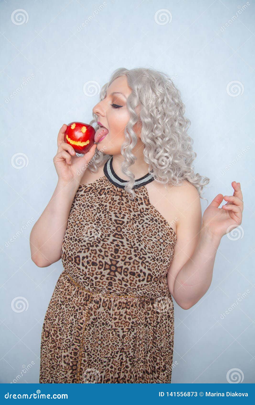 Chubby Blonde Girl Wearing Summer Dress And Posing With Big Red Apple On White Background Alone