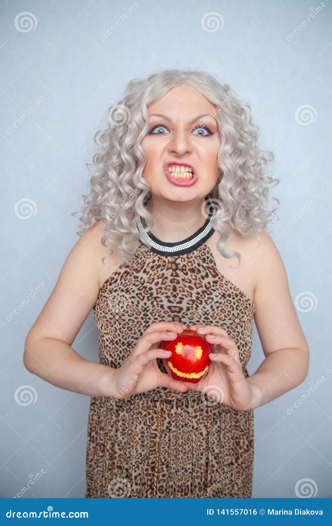 Chubby Blonde Girl Wearing Summer Dress And Posing With Big Red Apple On White Background Alone