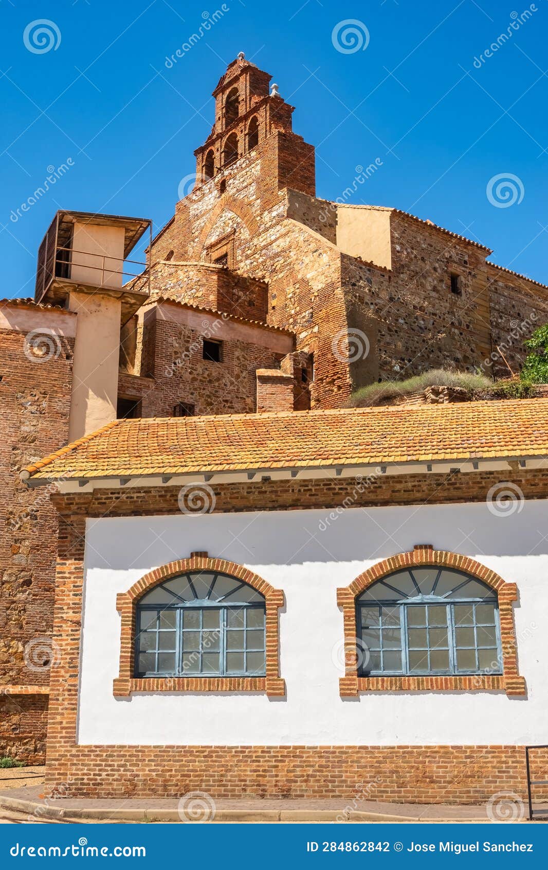 church tower and old buildings in the closed mine of almacen, ciudad real, spain.