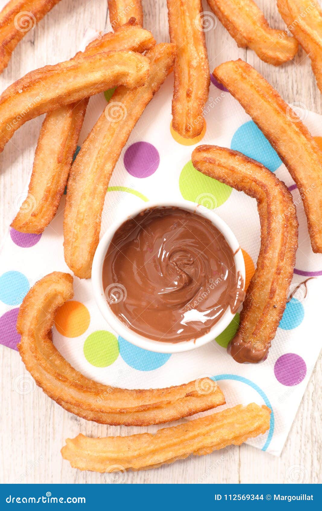 Churros and chocolate dip stock photo. Image of holiday 112569344