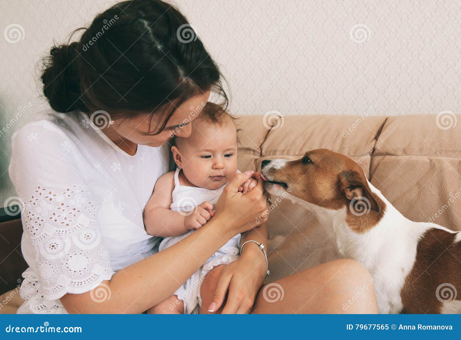 Chéri et crabot. Jeune mère avec son bébé mignon jouant avec le chien de terrier de Russel de cric