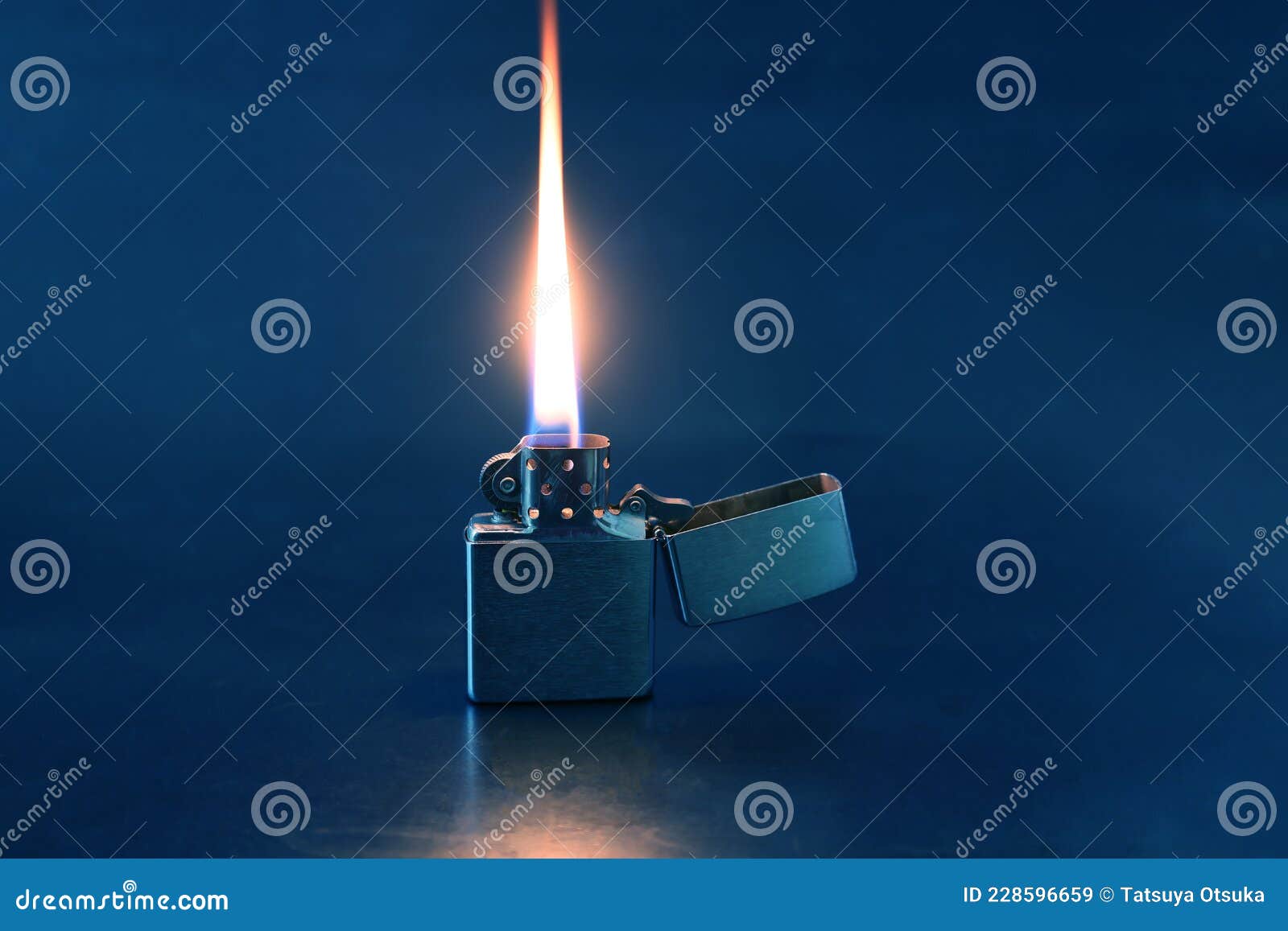 Cigarette Lighter and Its Flame Isolated on a Black Back Ground Stock