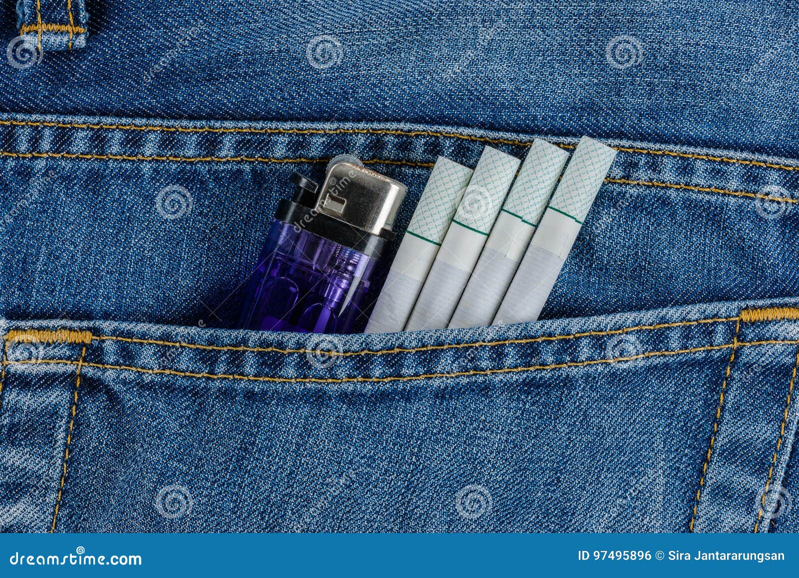 Cigarettes and Cheap Lighter in Old Blue Denim Jeans Pocket Stock Photo