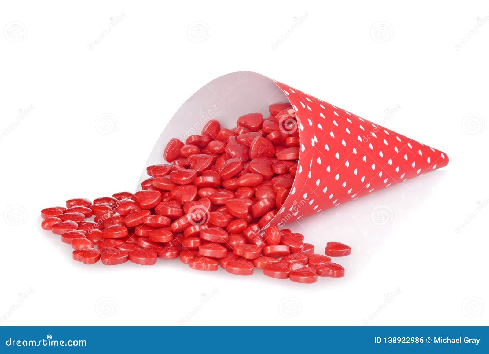 Cinnamon Hearts Spilling from Red Heart Cone Stock Photo - Image