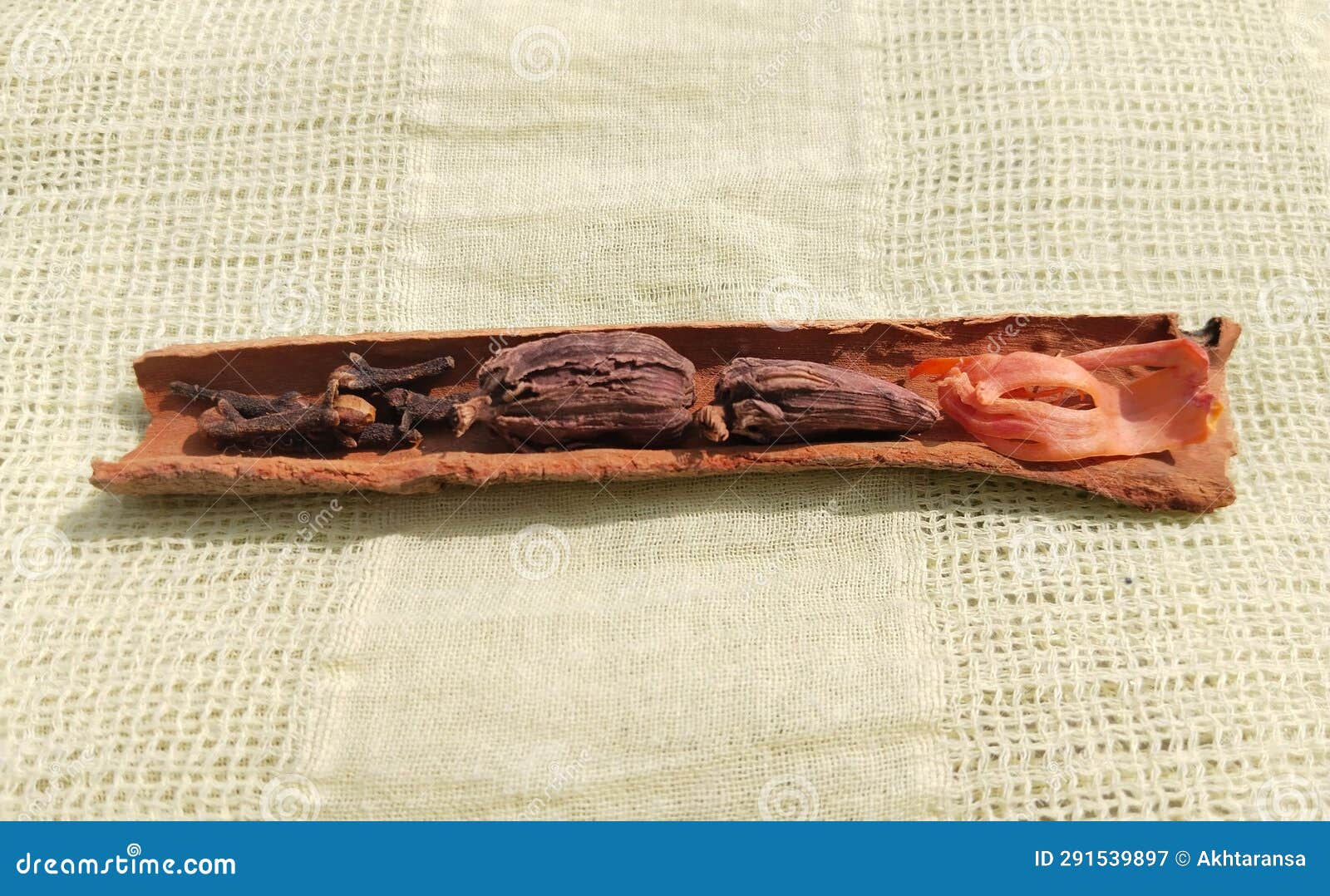 cinnamon sticks, clove and black cardamom (amomum subulatum)  on yellow cloth background. copy space,
