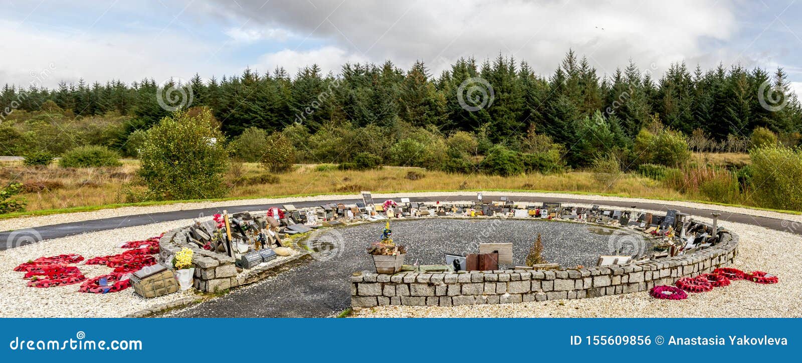 A Circle Shaped Garden Of Remembrance With Red Wreathes And
