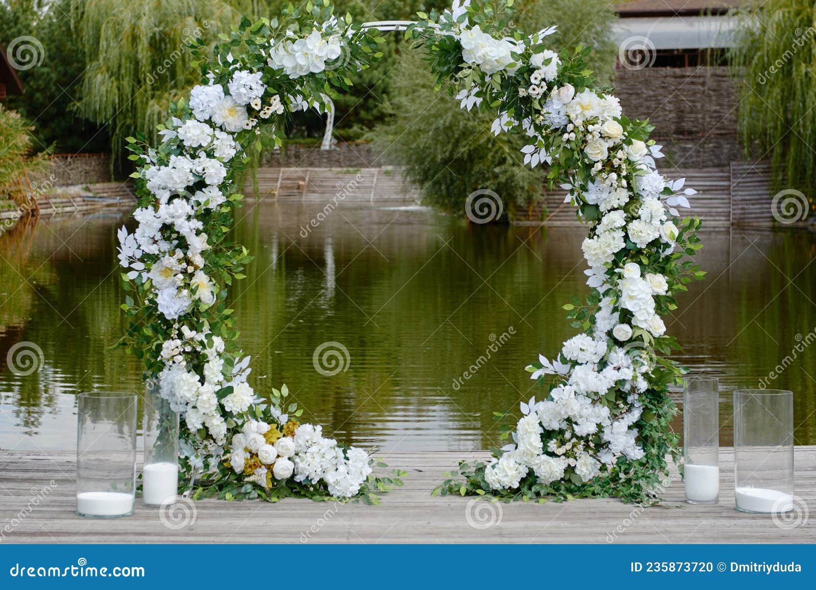 Circle Wedding Arch Decorated with White Flowers and Greenery Outdoors