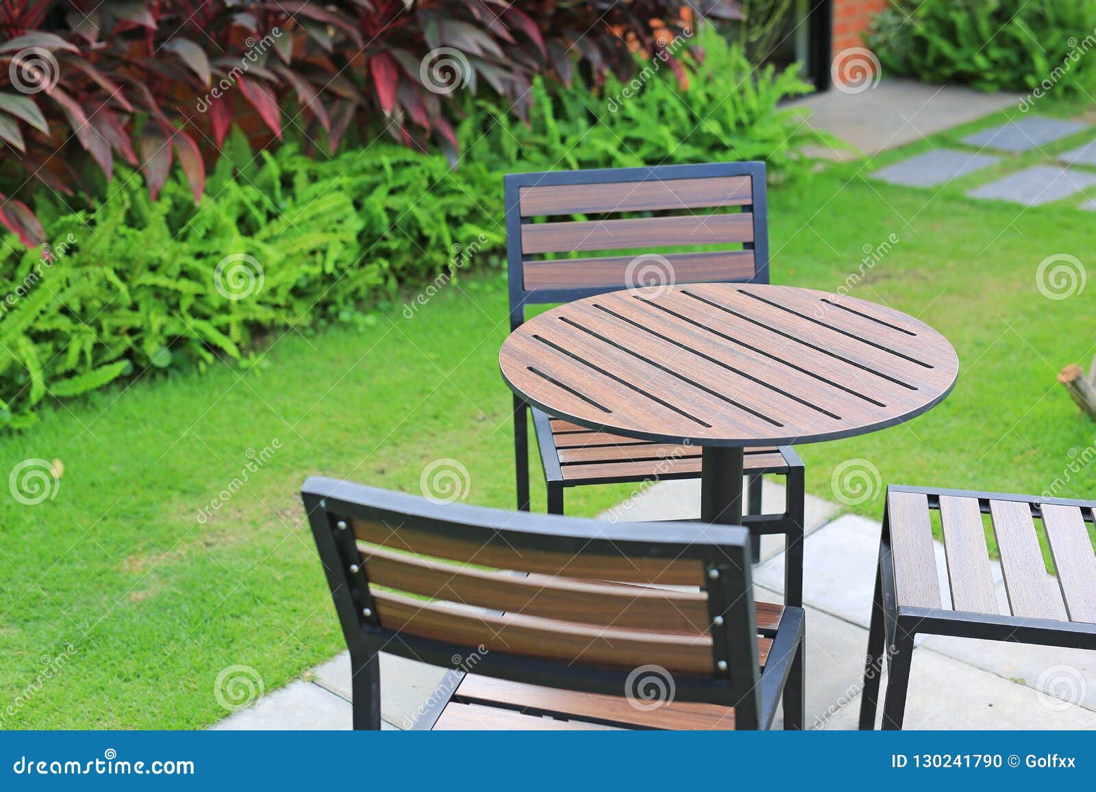 Circle Wood Table With Chair In The Green Garden Stock Photo