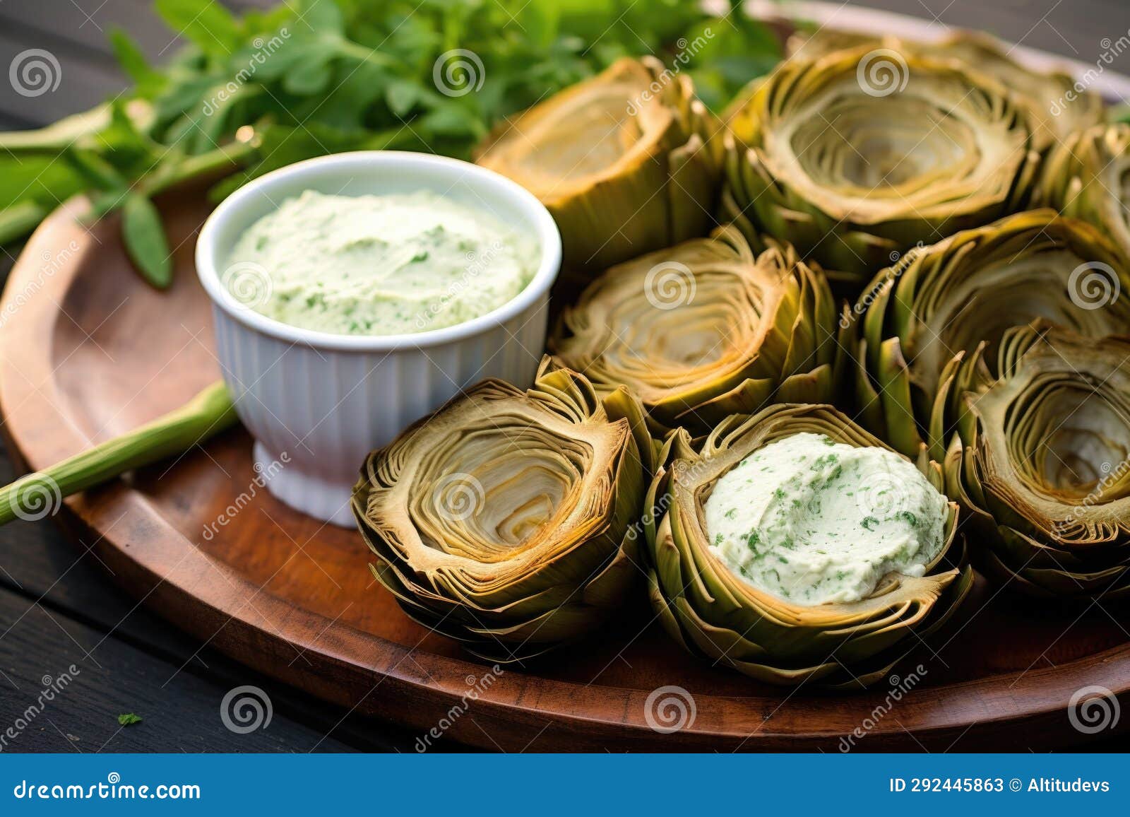 Circular Arranged Grilled Artichokes Around a Garlic Dip Stock Image