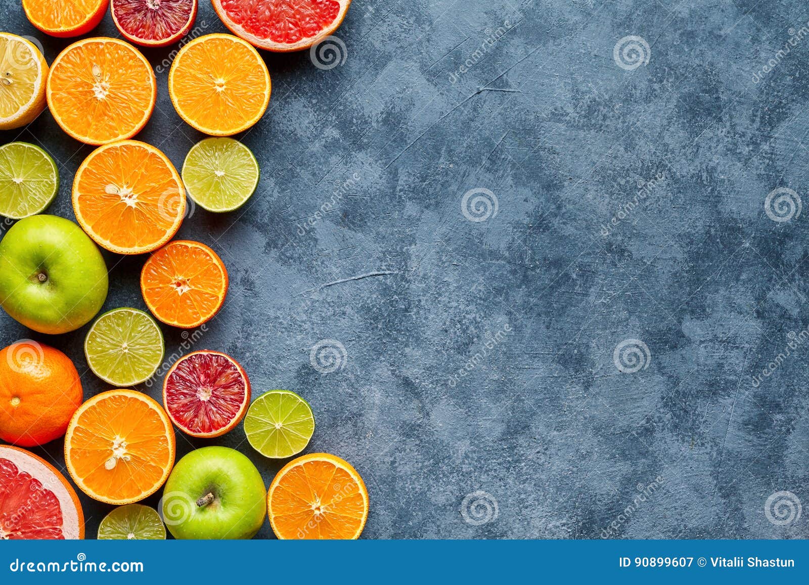 citrus fruit mix on dark grey concrete table. food background. healthy eating. antioxidant, detox, dieting, clean eating