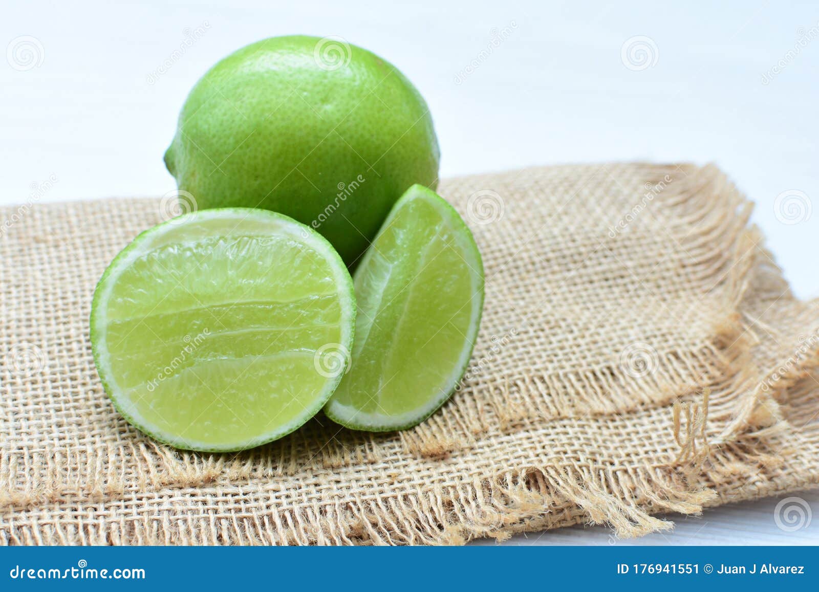 citrus - latifolia, persian lemon, tahitian lemons whole and in pieces accompanied by salt