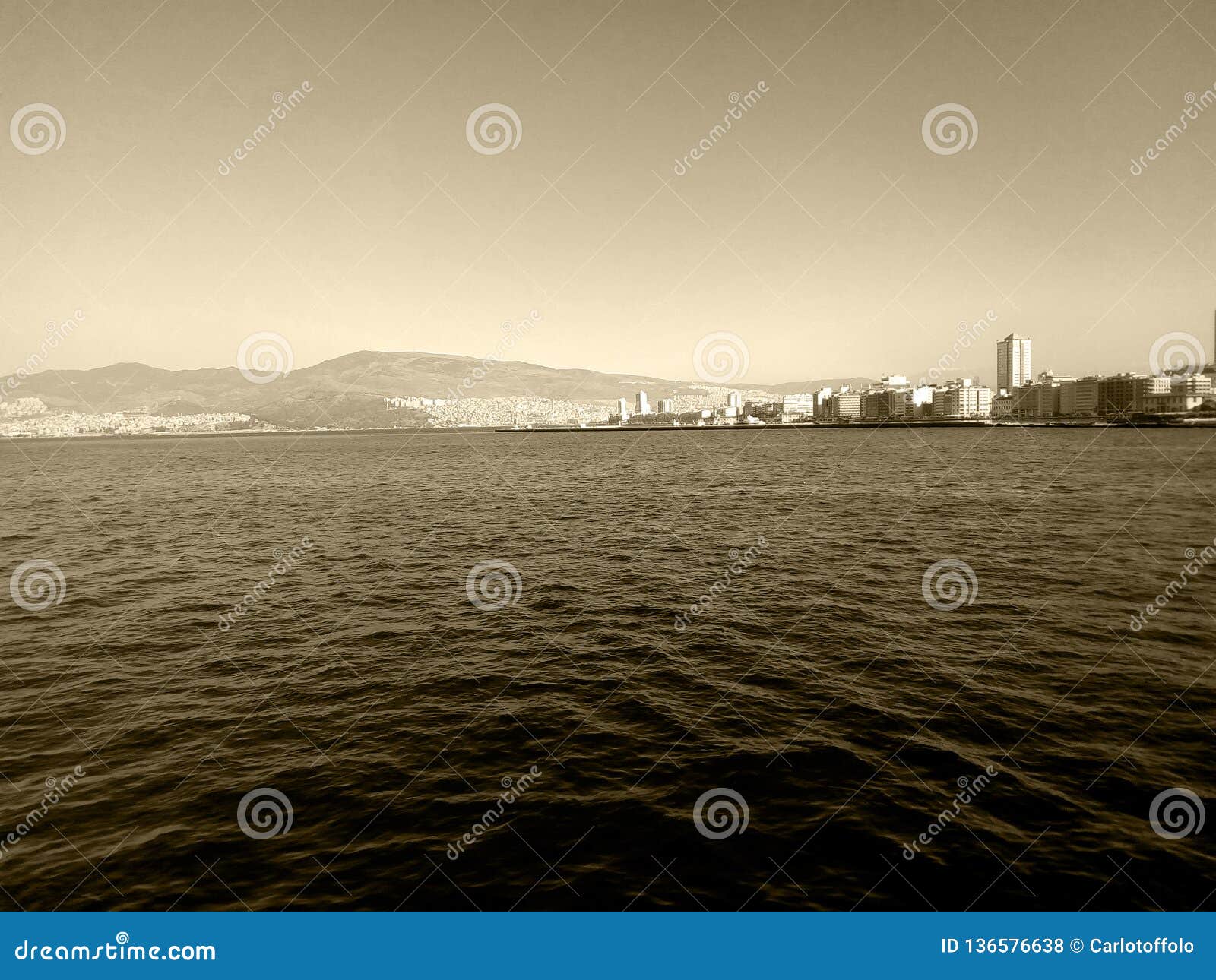 cityscape of izmir - alsancak turkey from the sea - sepia photography
