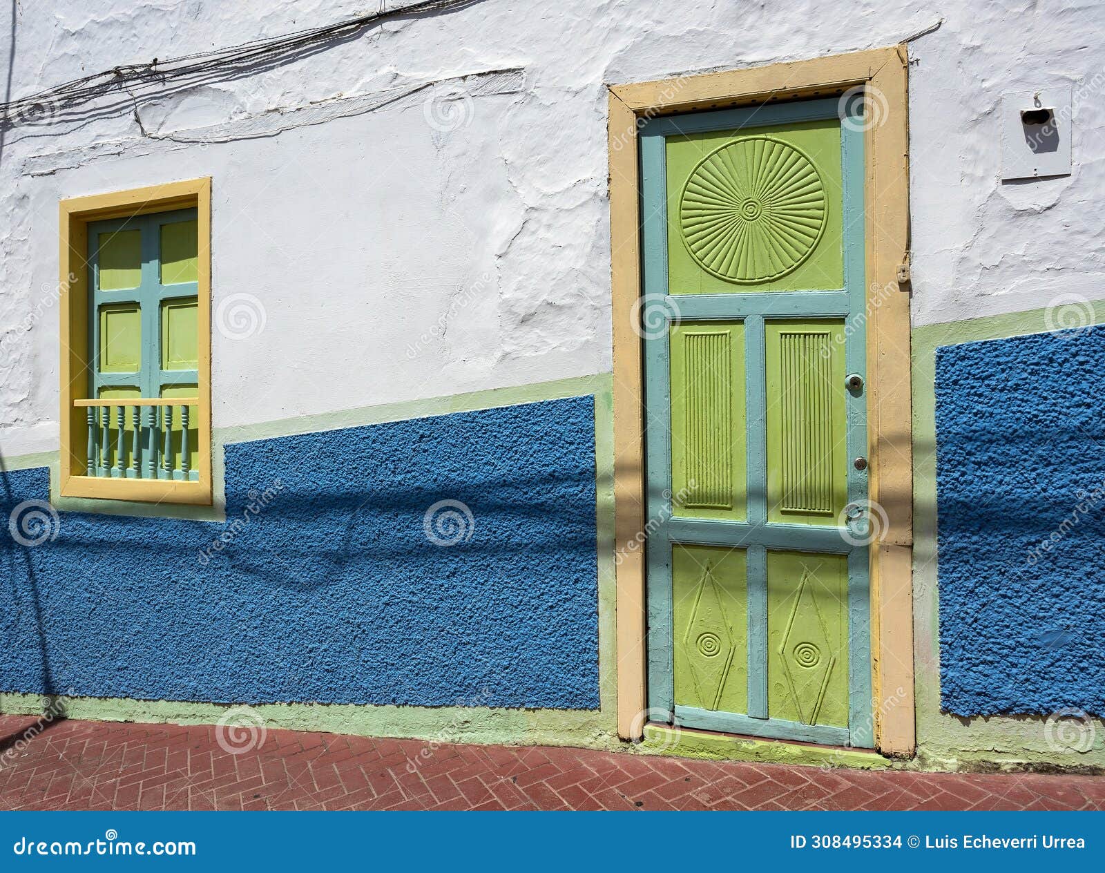 ciudad bolivar, antioquia - colombia. february 21, 2024. traditional colombian architecture, white facade with green doors and
