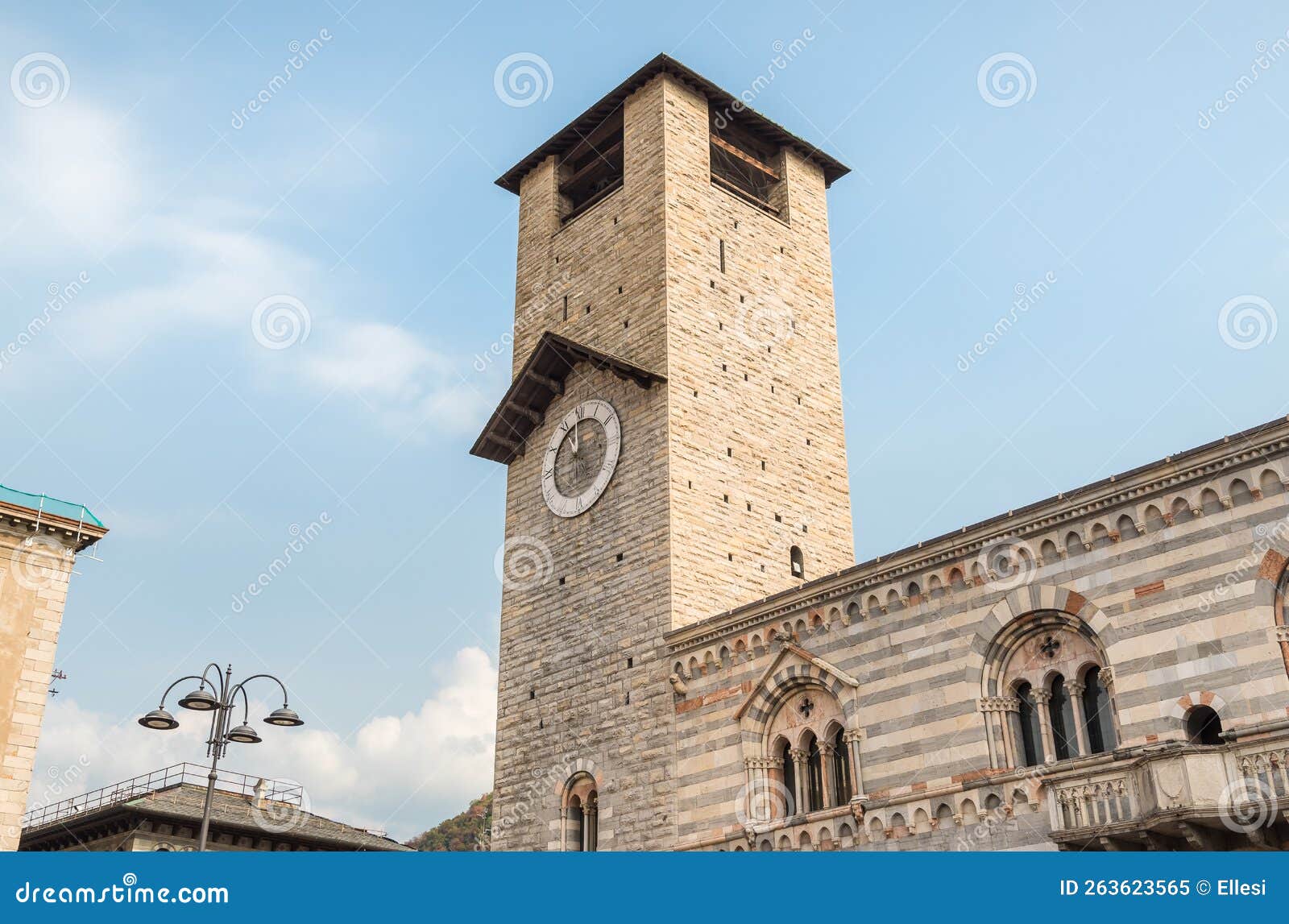 the civic tower with clock of the cathedral d`uomo in como, italy