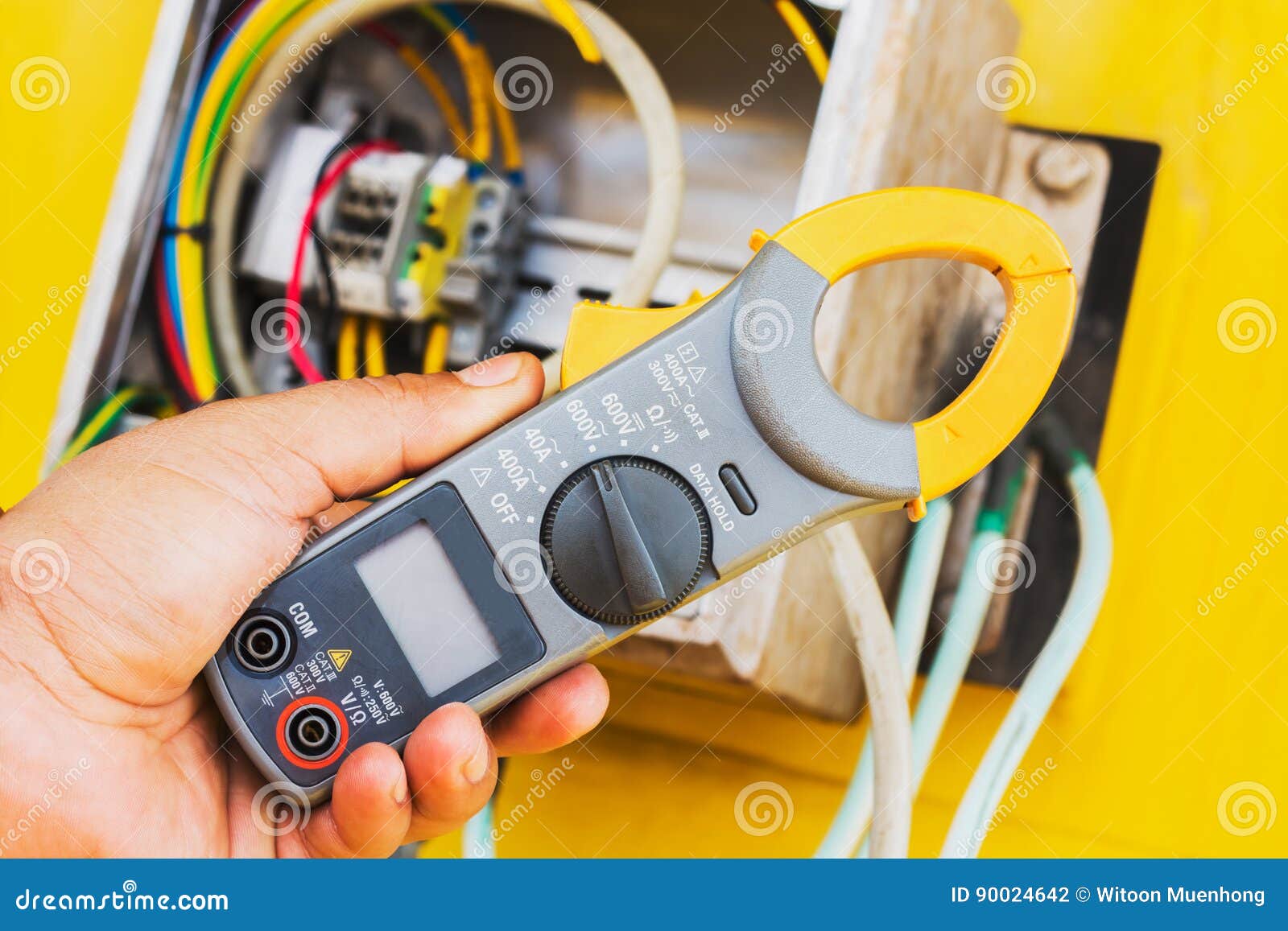 Clamp Amp Meter, Hand of Electrician with Clamp Amp Meter Stock Photo