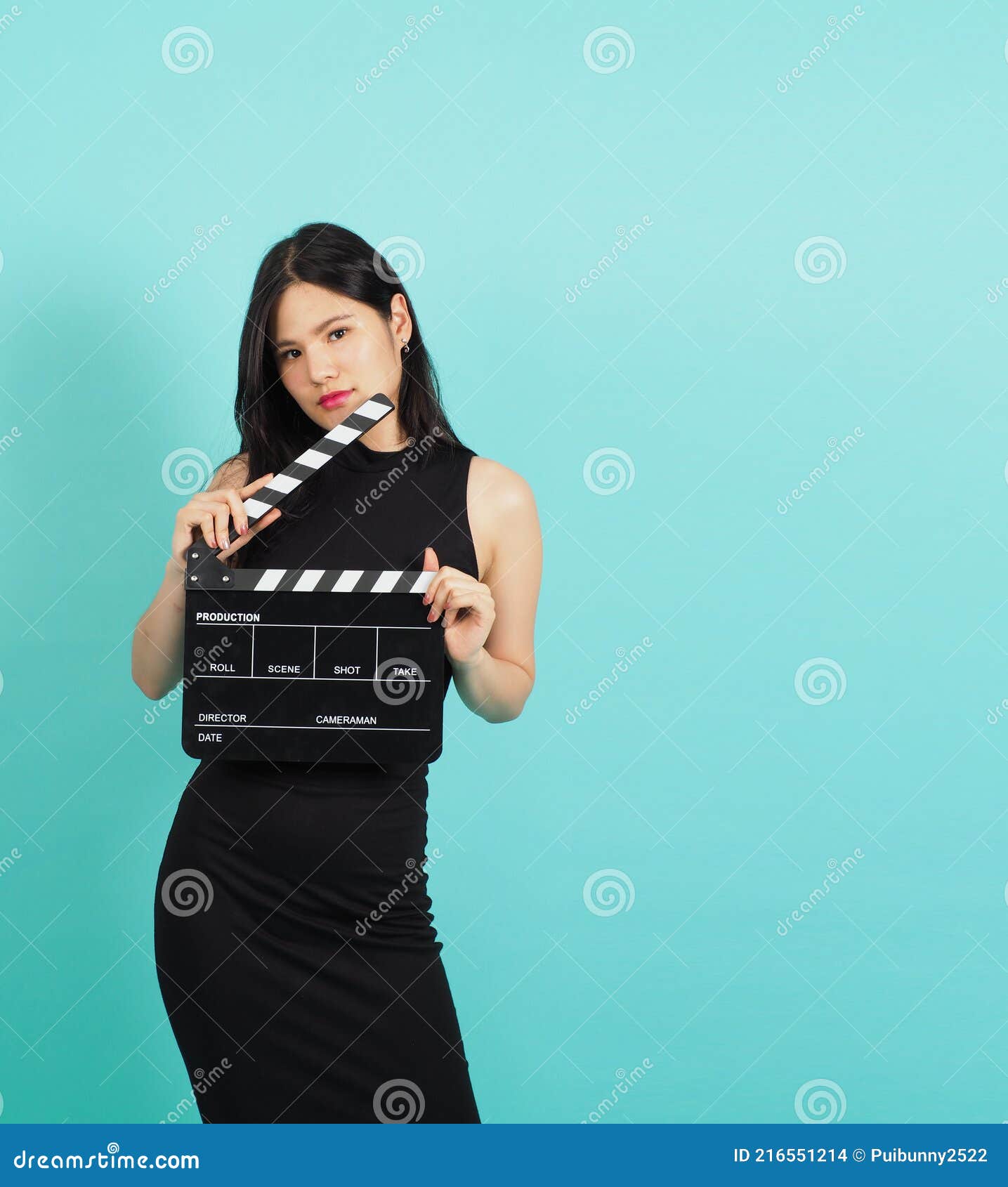 Clapper Board or Movie Clapperboard in Teenage Girl or Woman Hand.it Use in Video Production ,film, Cinema Industry on Green or Stock Photo