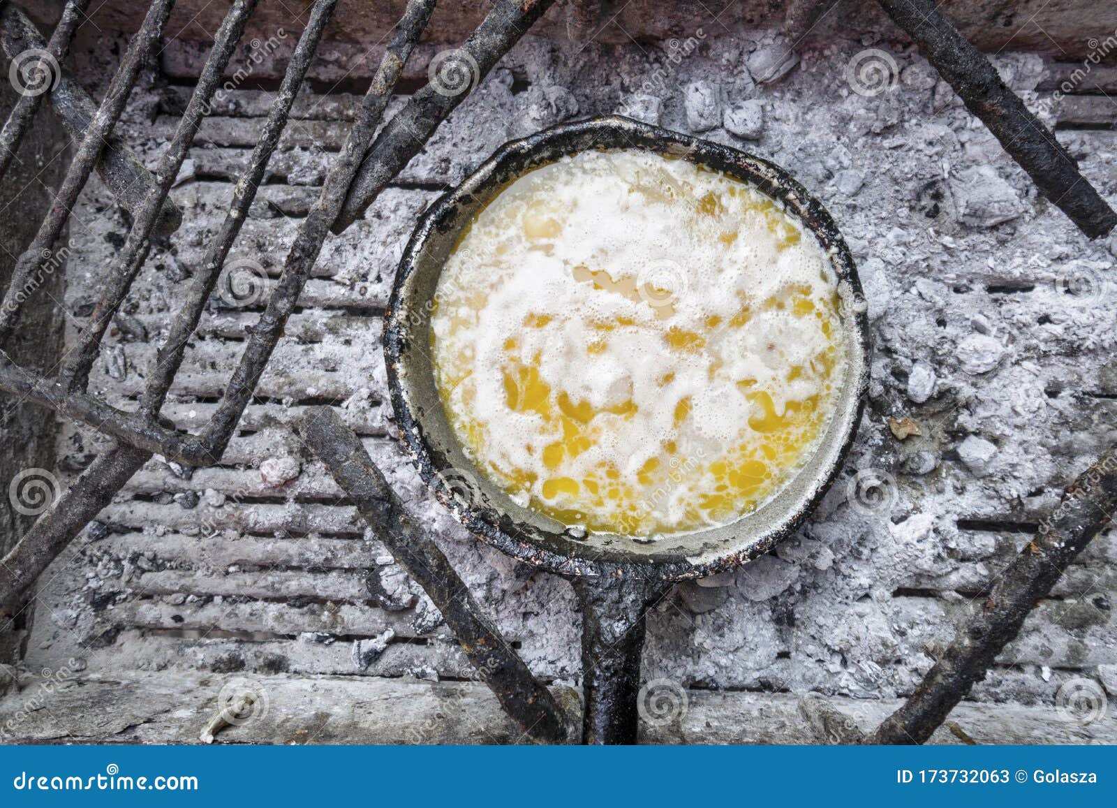 clarifying butter on the frying pan on charcoal in mozambique
