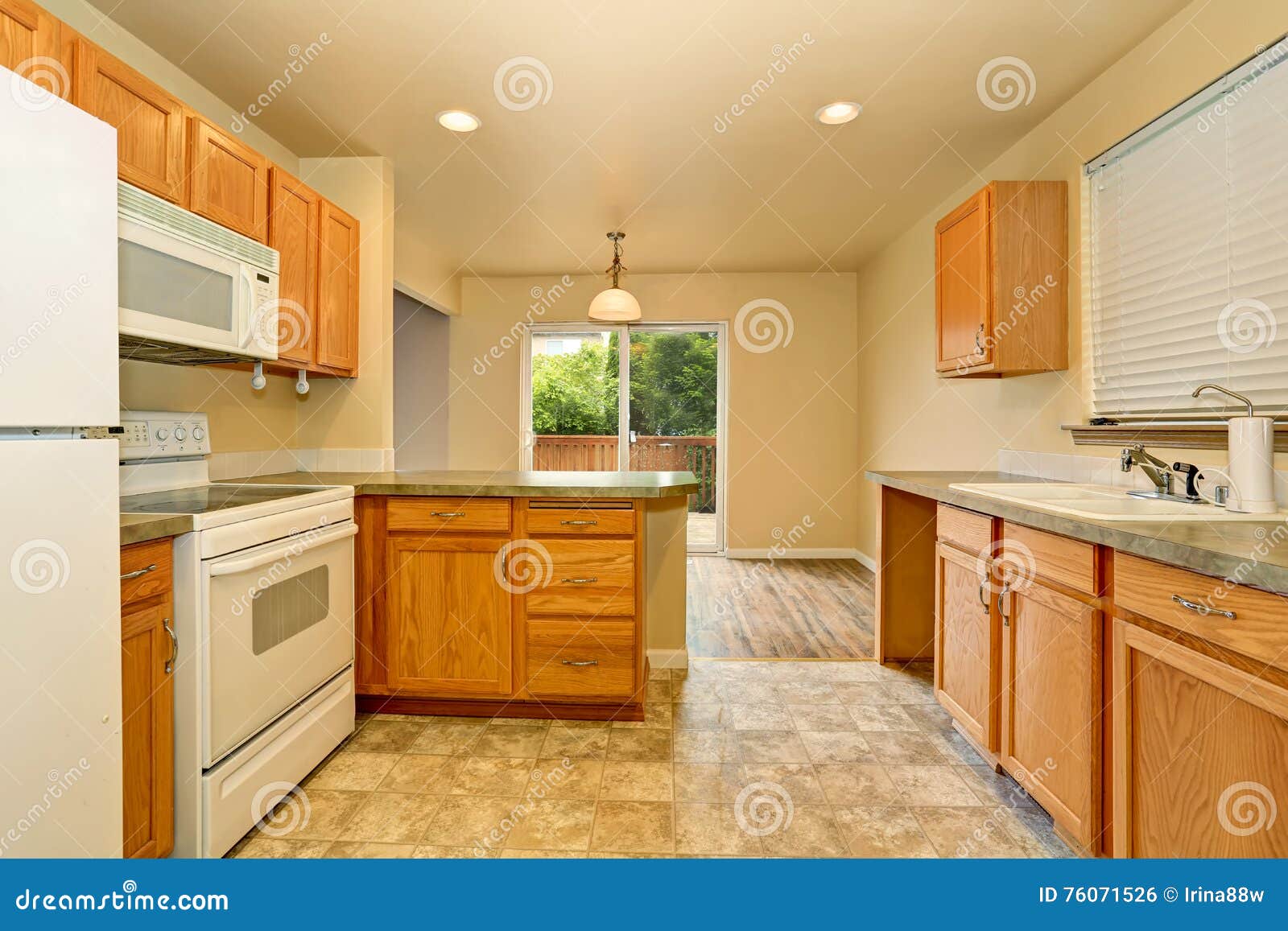 Classic American Kitchen Room With Wooden Cabinets And Tile Floor