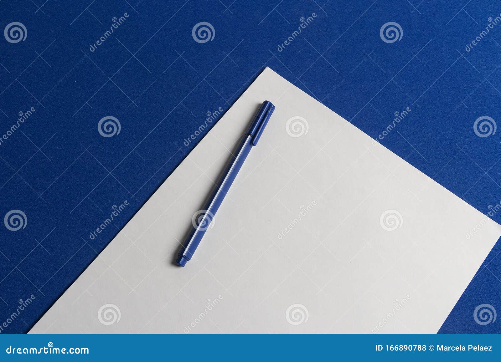 classic blue table with blank sheet of paper and blue pen ready for 2020 goals