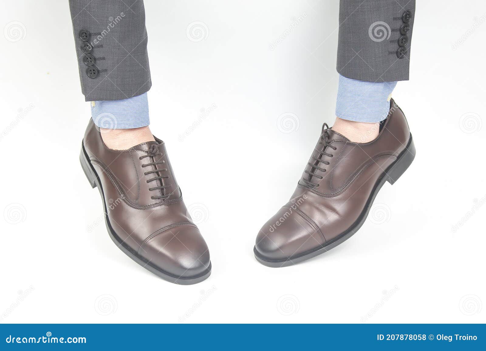 Classic Brown Leather Shoes Worn on the Hands on a White Background