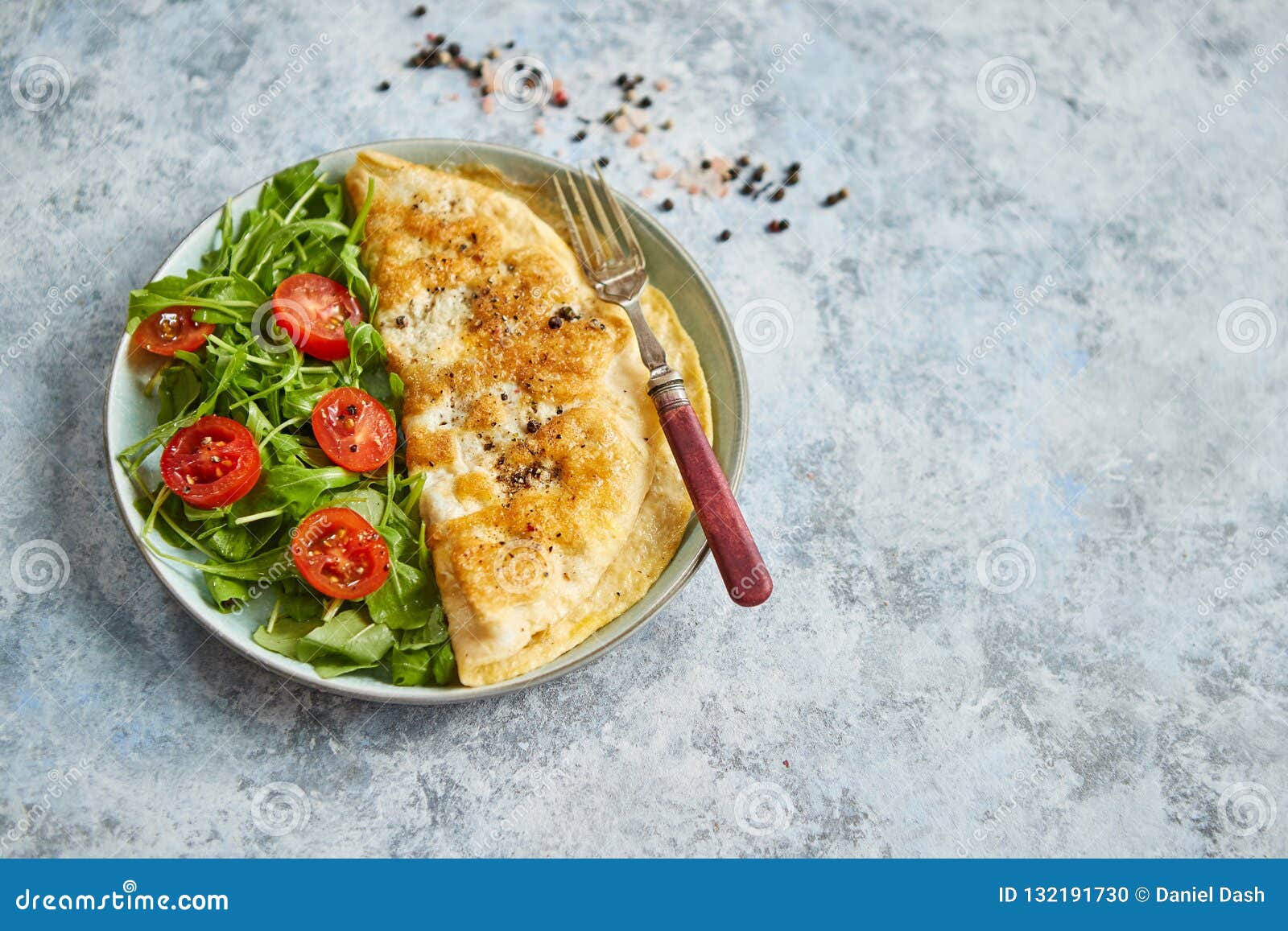 Classic Egg Omelette Served with Cherry Tomato and Arugula Salad on ...