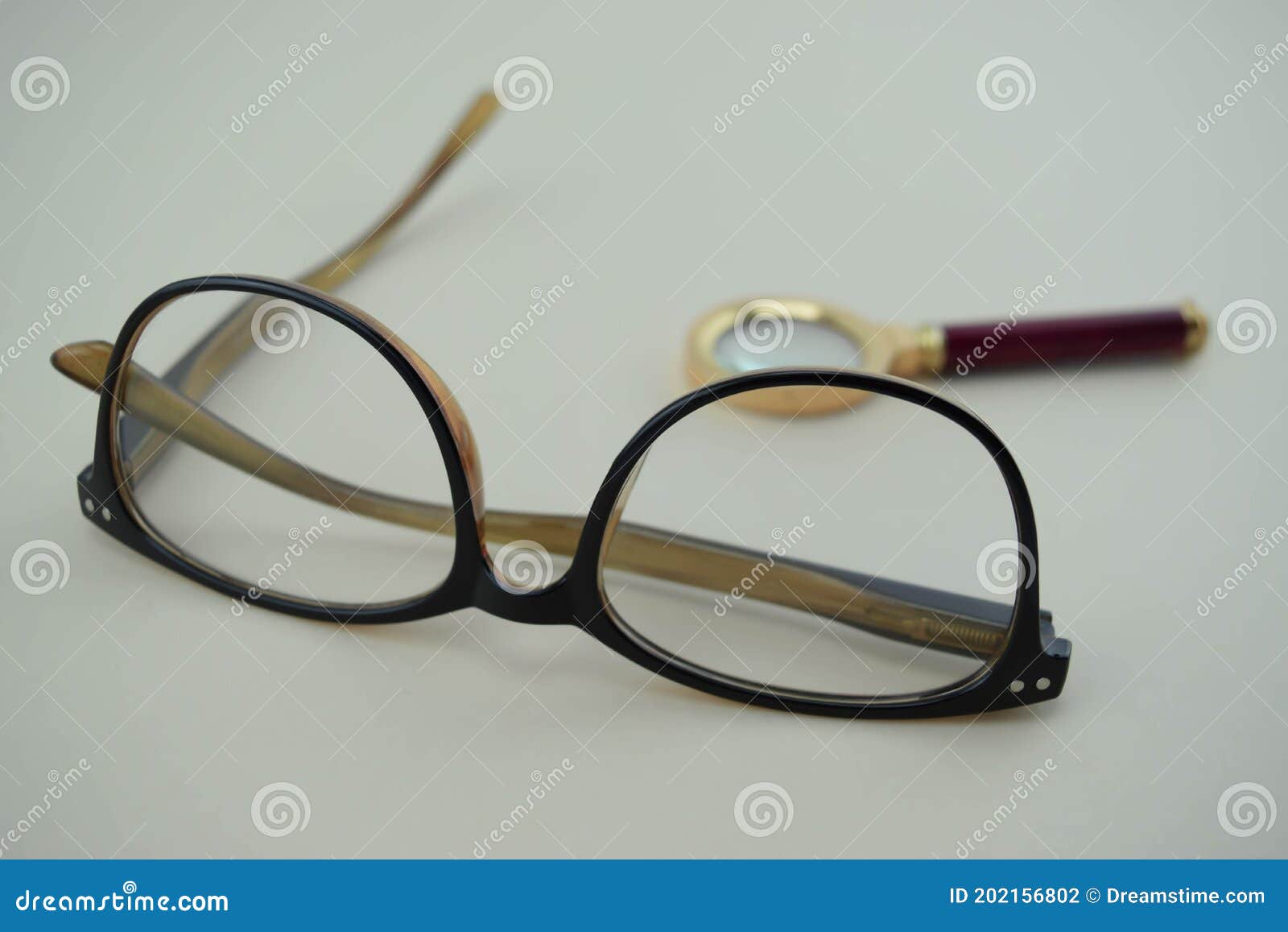 classic eyeglasses with magnifying glass behind