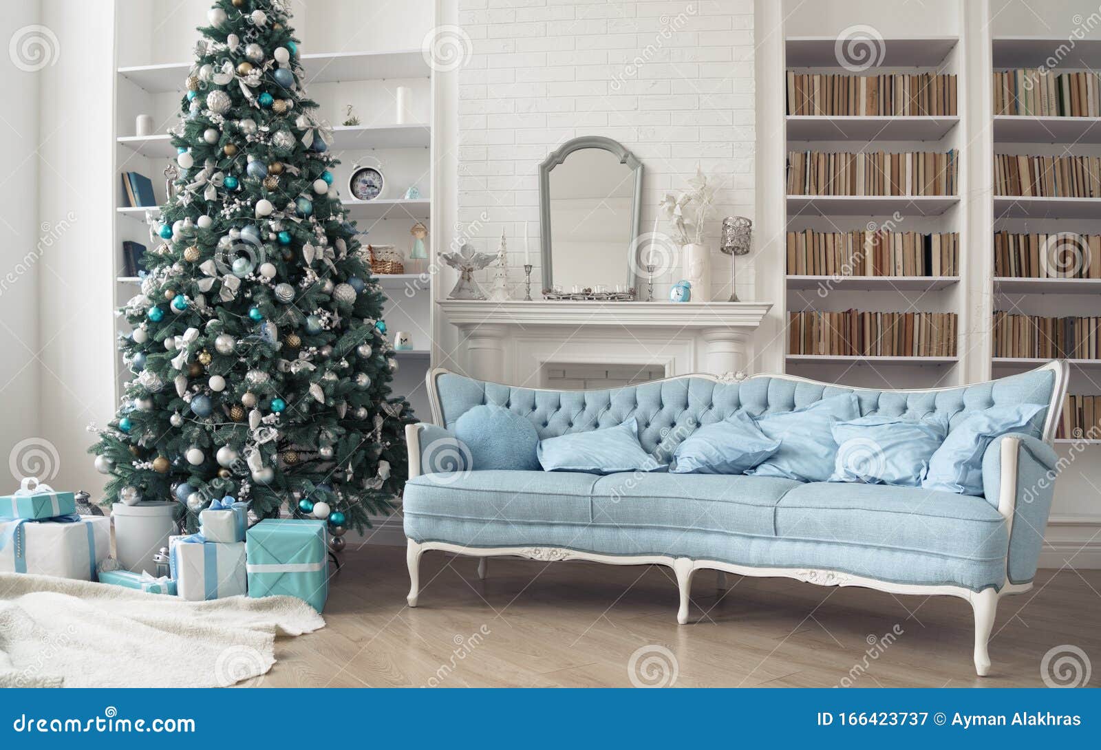 Classic French Blue Sofa And Decorated Christmas Tree With Gift Boxes Beneath In Living Room
