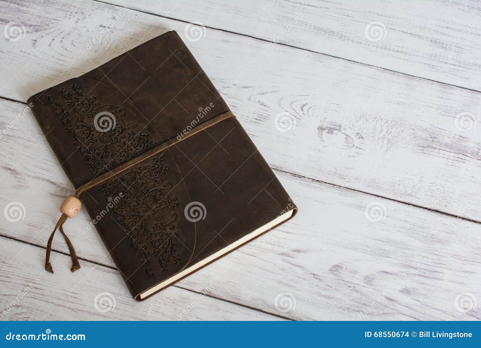 Classic Leather Bound Journal Book on a White Barn Board Floor Close Up