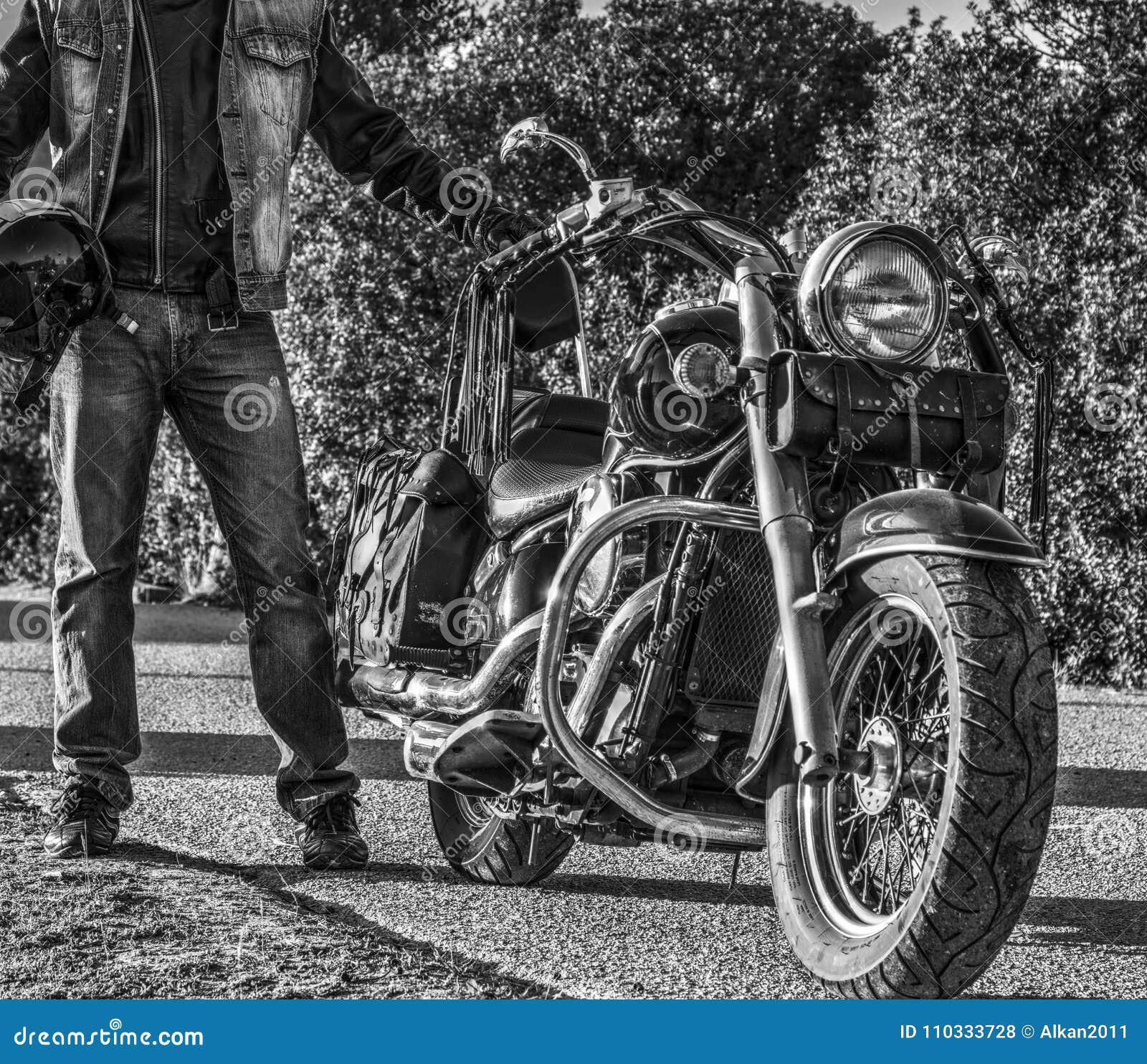 Classic Motorcycle and Biker on the Edge of the Road in Black an Stock ...